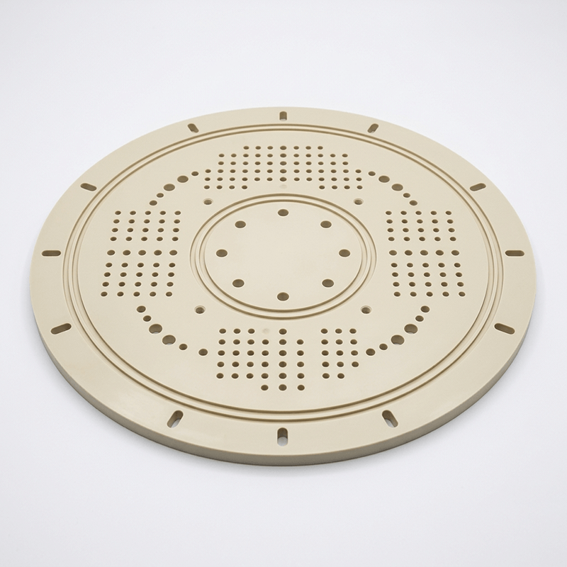 A round beige plastic press plate with multiple small holes and slots, likely used for steaming or cooking.