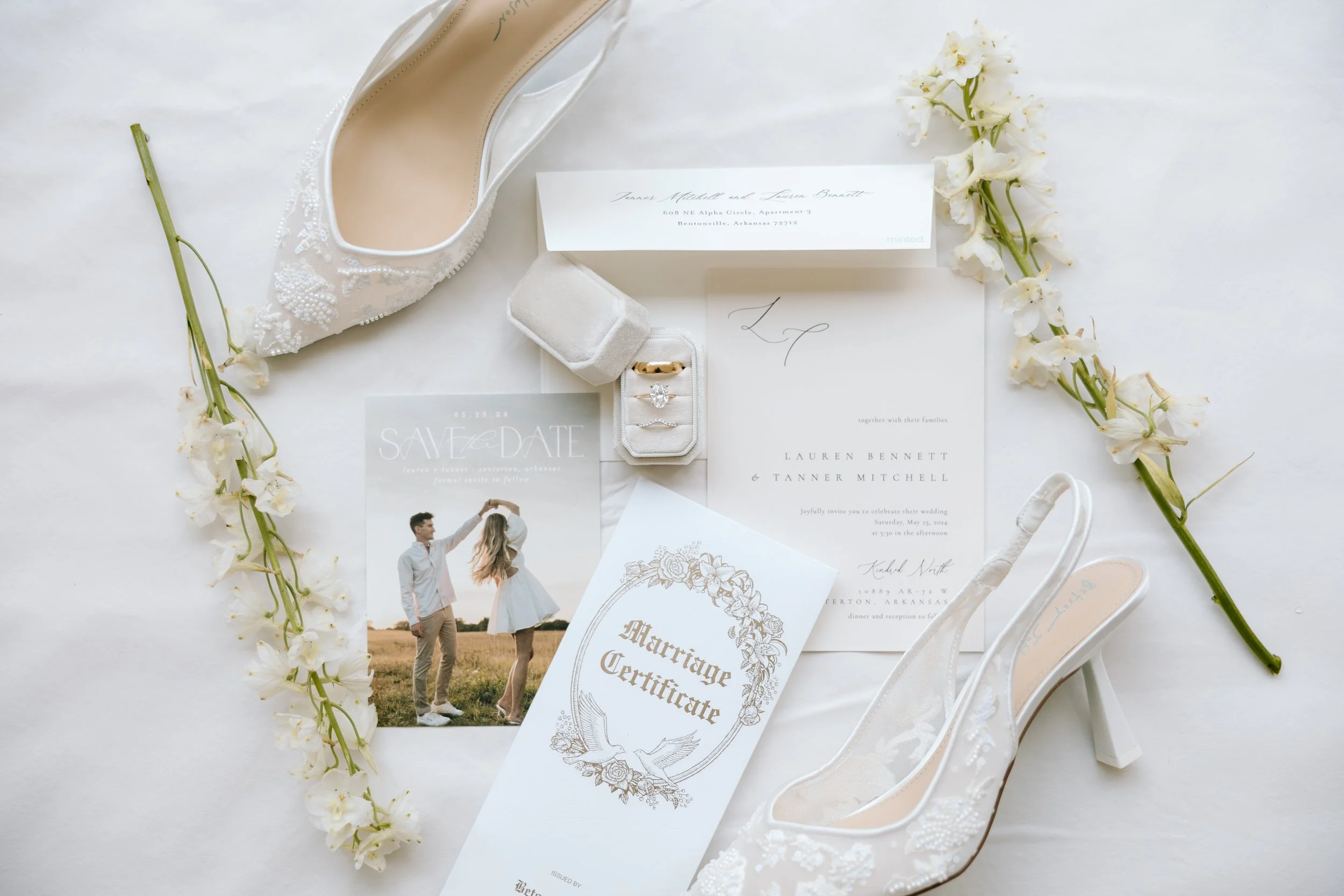 Wedding invitation, marriage certificate, wedding shoes, engagement ring, wedding dress, flowers, and a wedding photo.