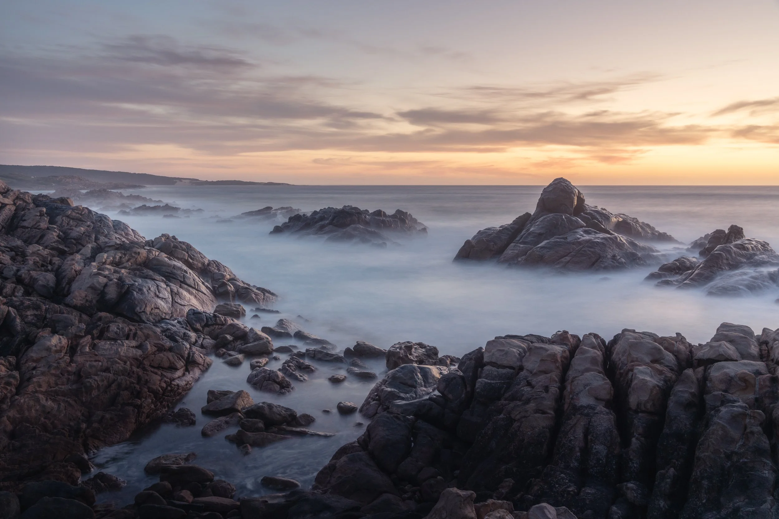 sunset-canal-rocks-ocean.jpg