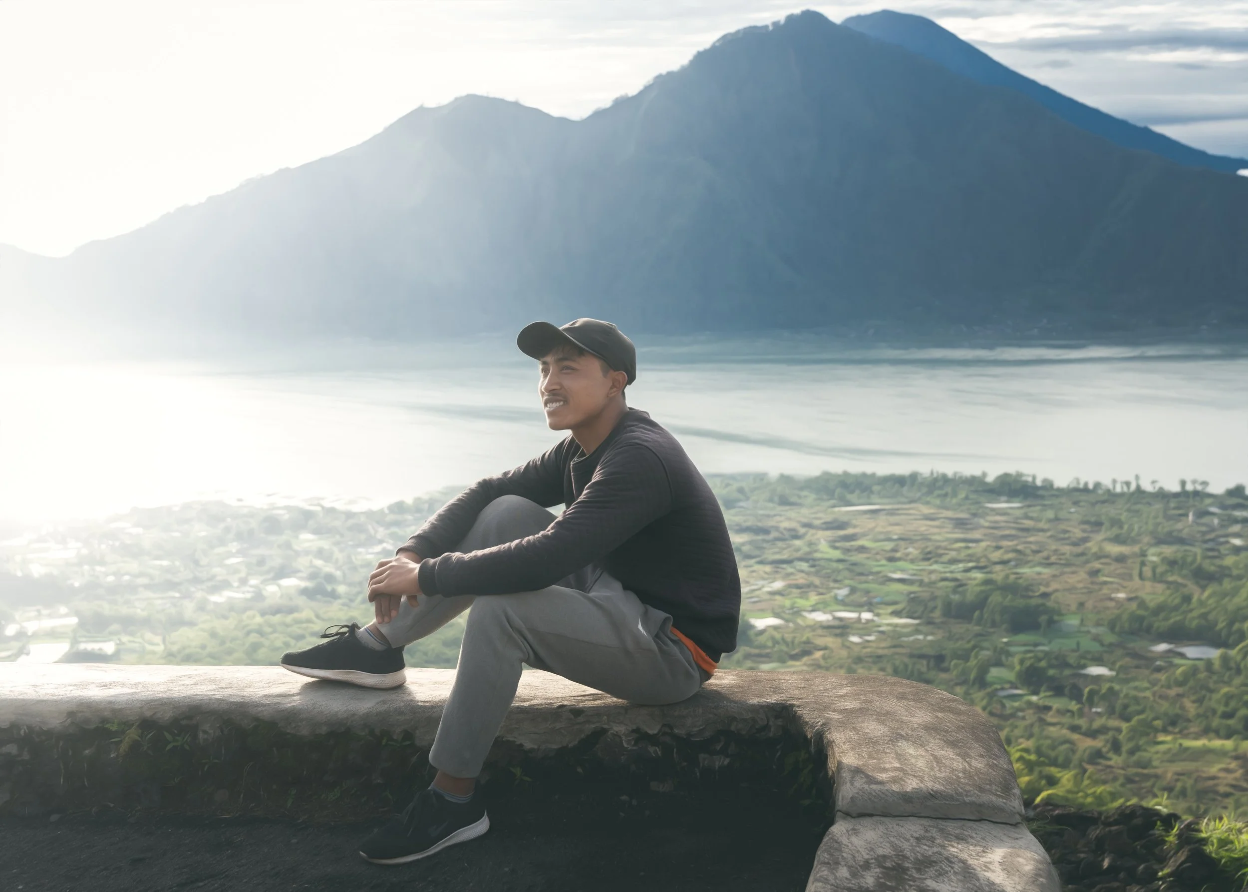 man-sitting-mountains-sea.jpg