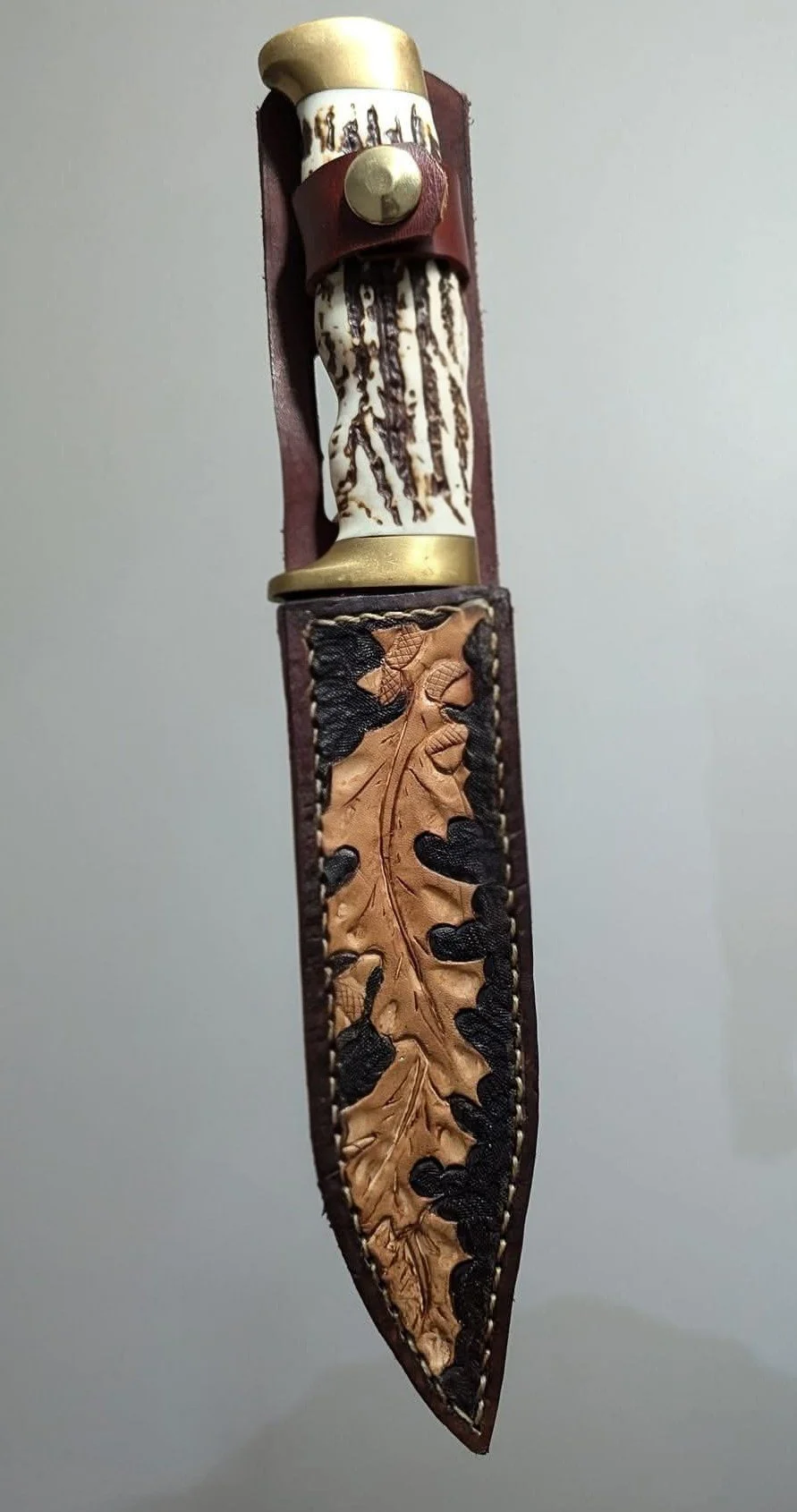 A custom kleather knife sheath with tooling