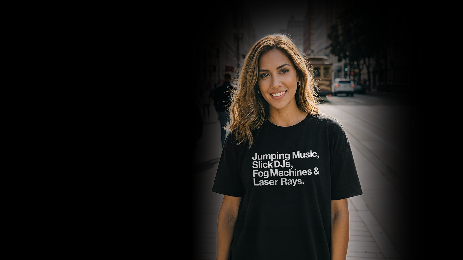 Person walking on the street at sunset wearing a black t-shirt with the words 'Music Sounds Better With You' written in white.