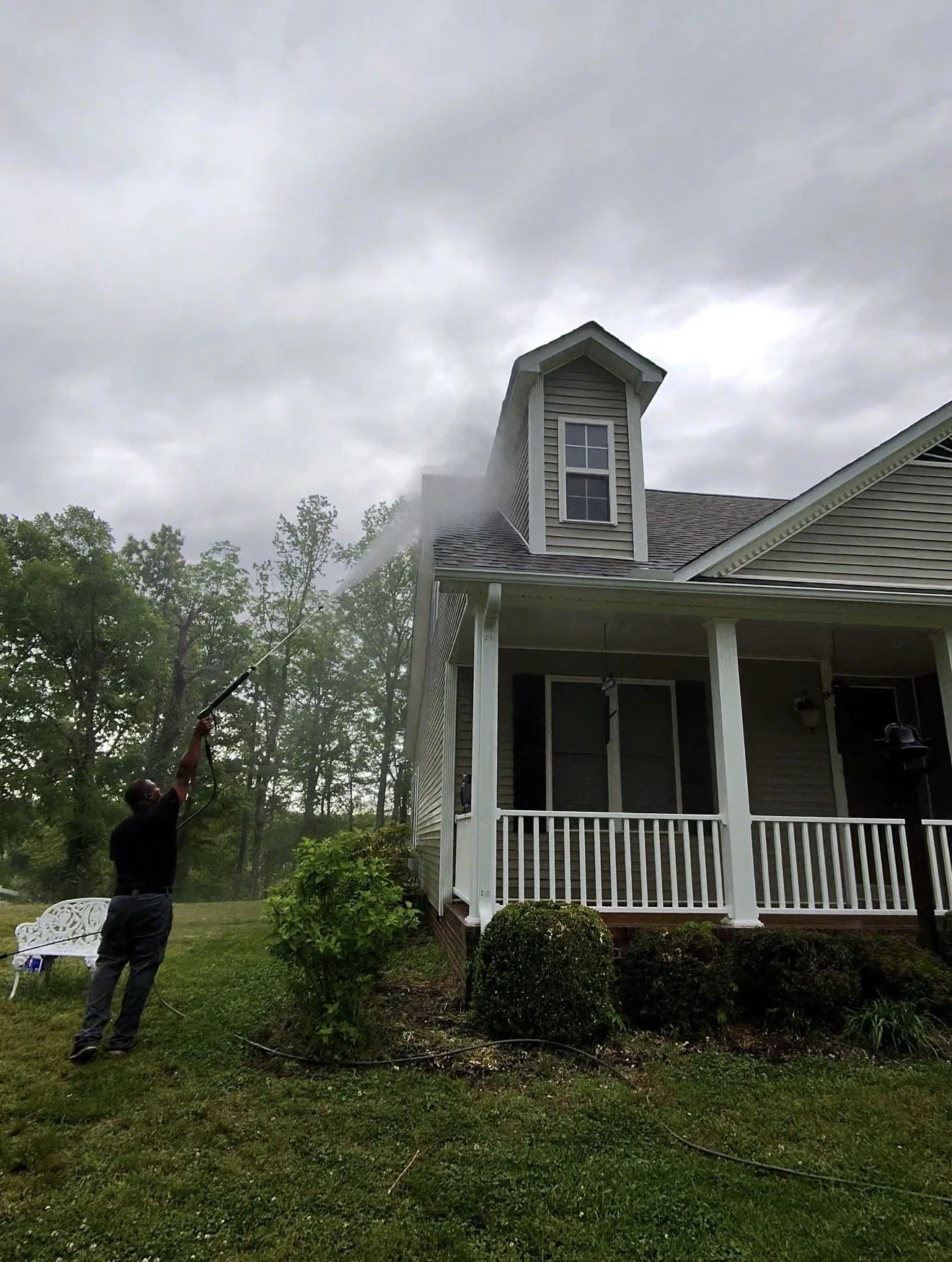 Removing years of algae growth from siding.