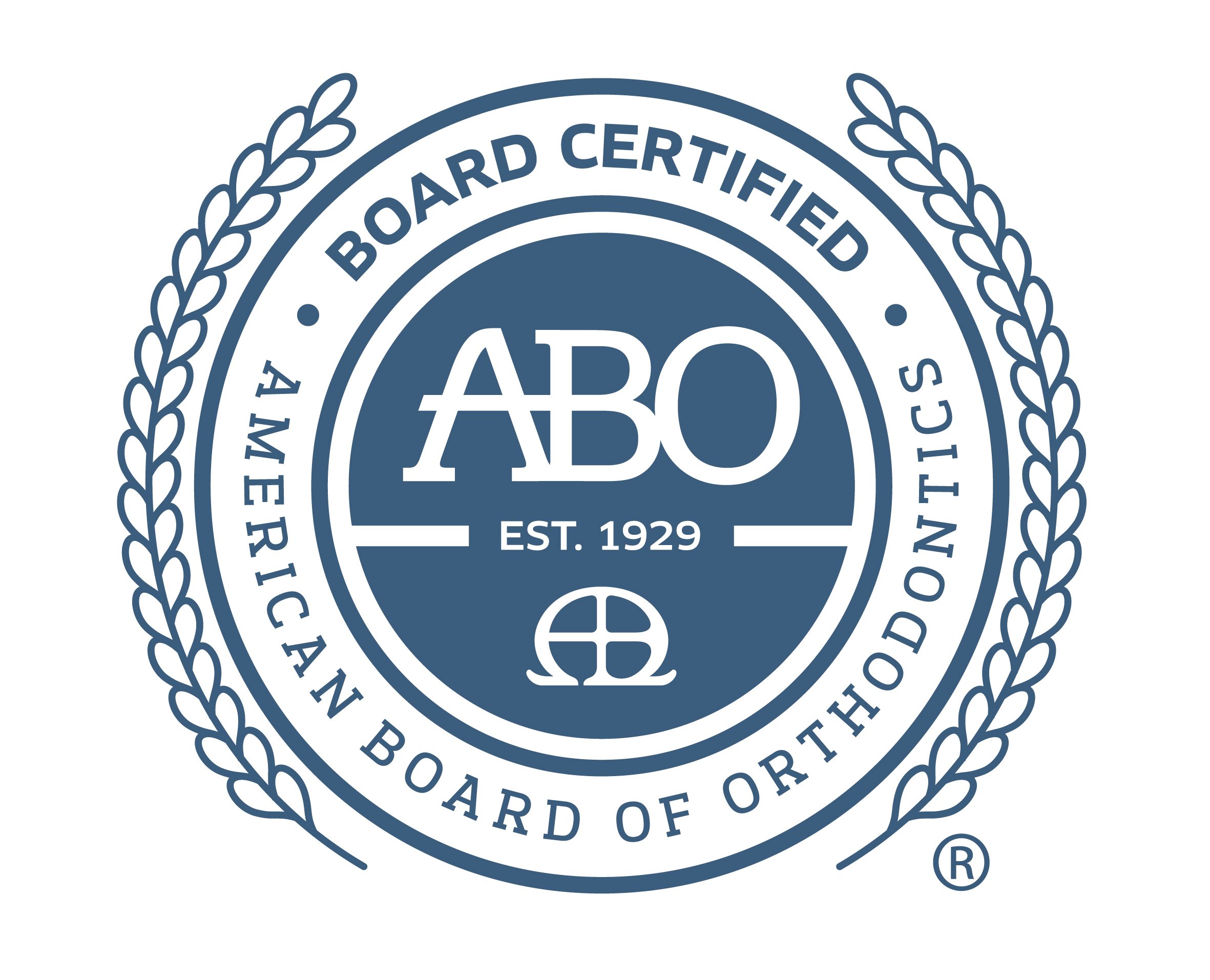 Close-up of a blue circular emblem featuring the words "BOARD CERTIFIED," "MASTER," and "EST. 1929" along with the ABO logo, surrounded by a laurel wreath design.