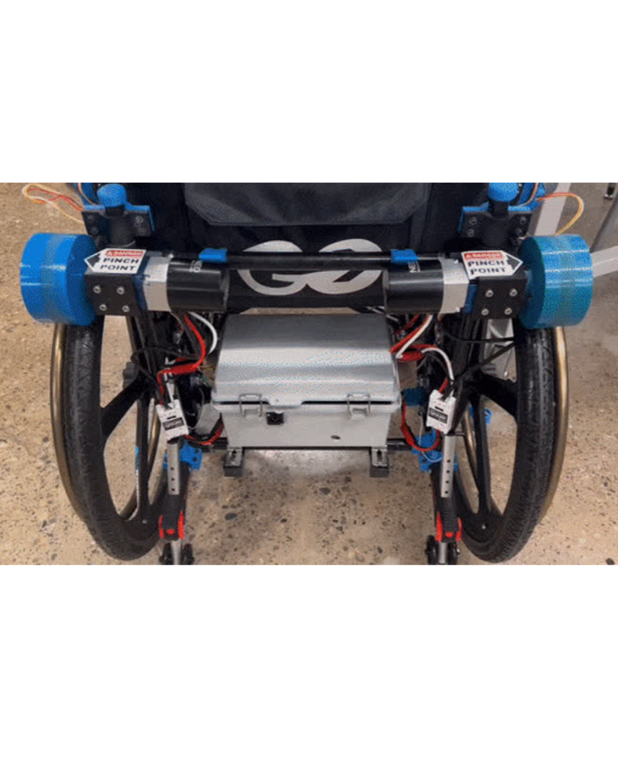 Rear view showing electronics enclosure and wiring on wheelchair.