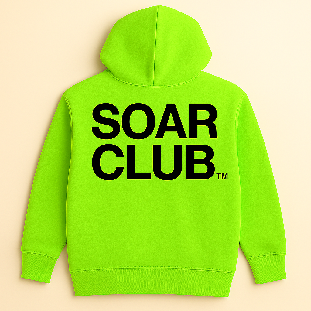 Bright green hoodie with bold black lettering saying "SOAR CLUB" on the back, hanging against a plain cream background.