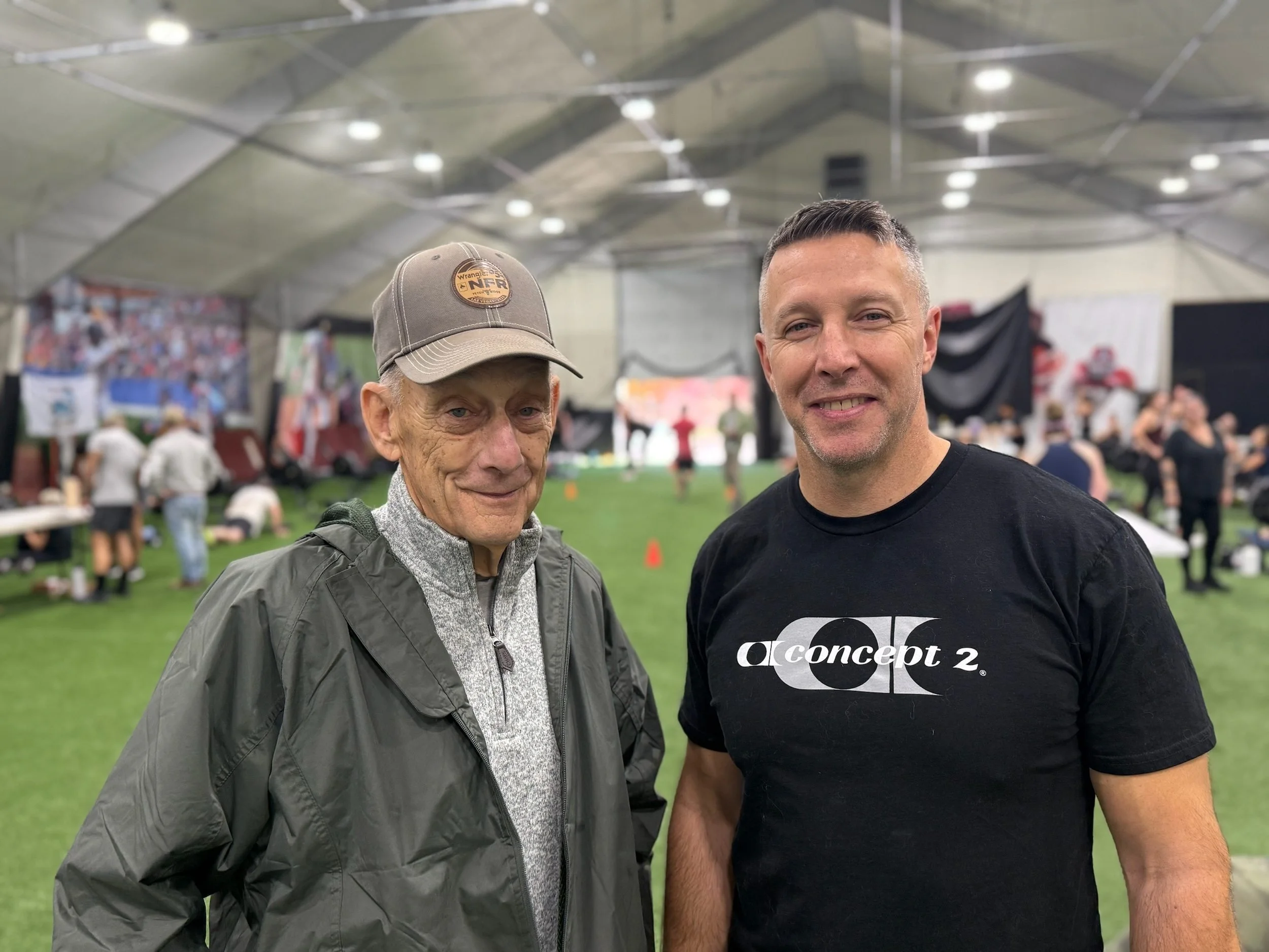 Two participants pose beside the DT’s Row 2025 workout area.