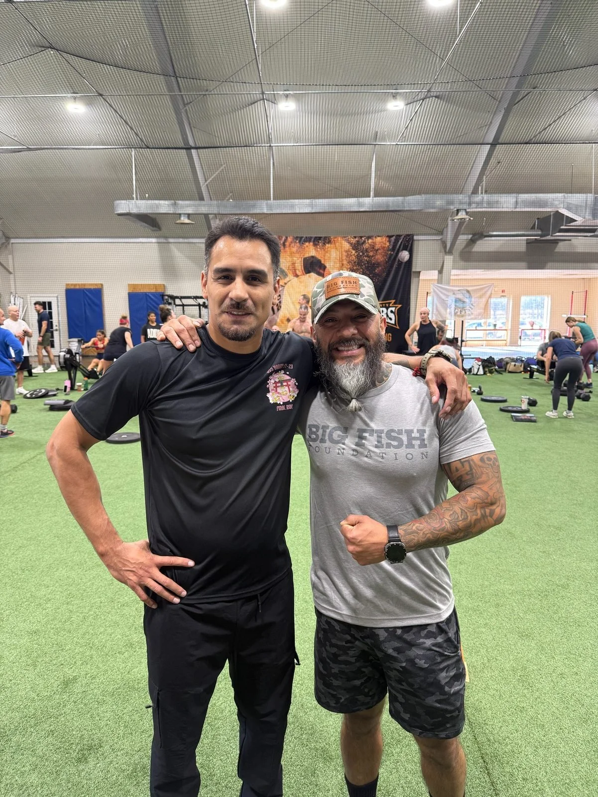 Two participants pose together on the workout floor at DT’s Row 2025.