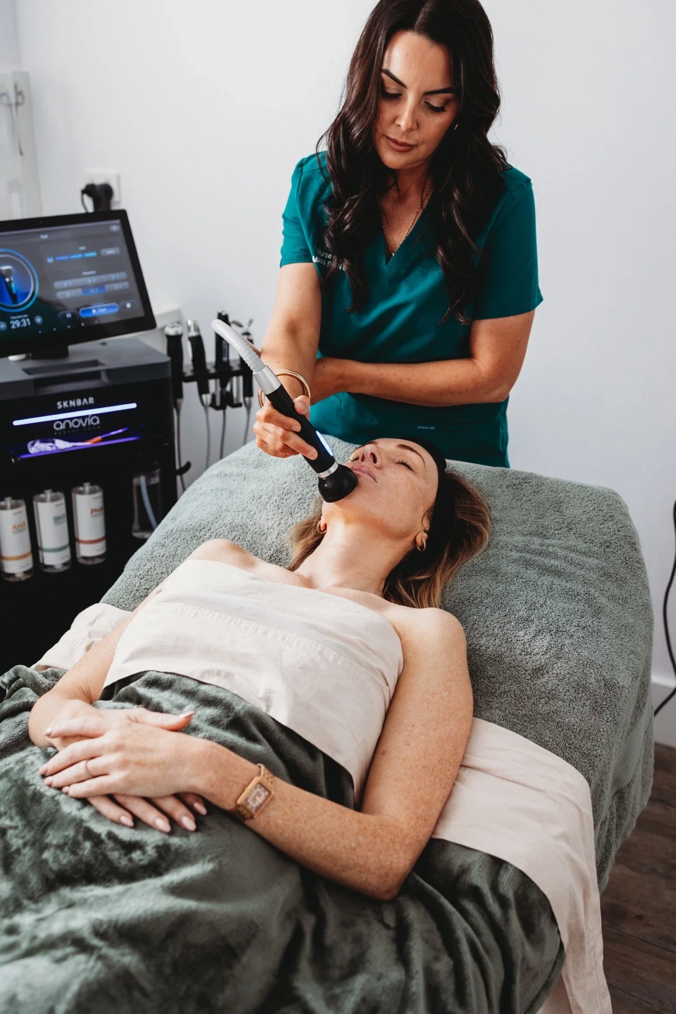 Client receiving a facial treatment from Nurse Alanna