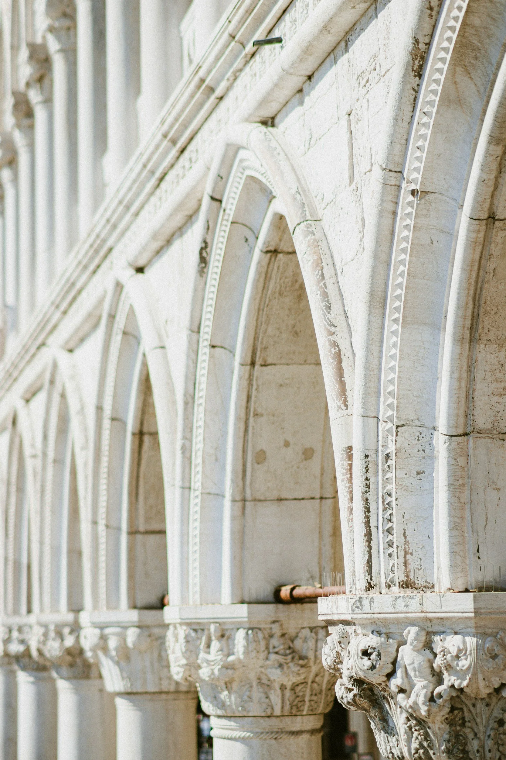 Ornate white arches in a building representing the discreet and refinement of The Ashmere.