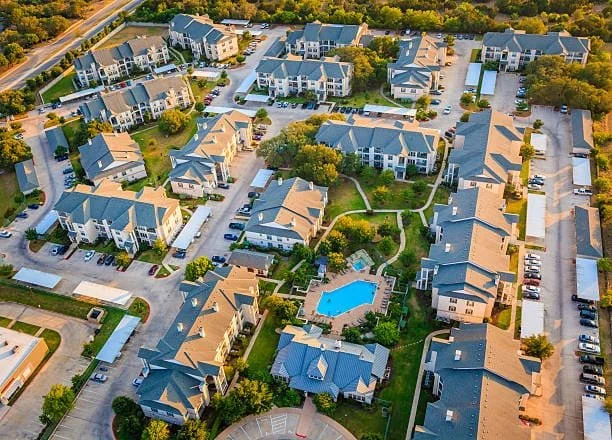 Aerial view of a condominium association's property, including the roofs and parking lots, which are key components of a long-term capital plan and reserve study.