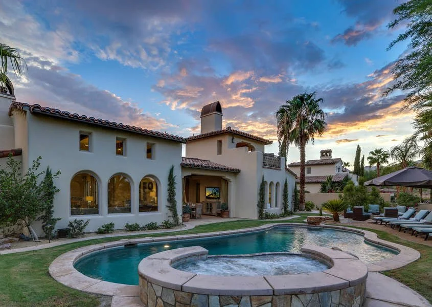Luxury short-term rental villa with a swimming pool at sunset, an ideal property for a cost segregation study.