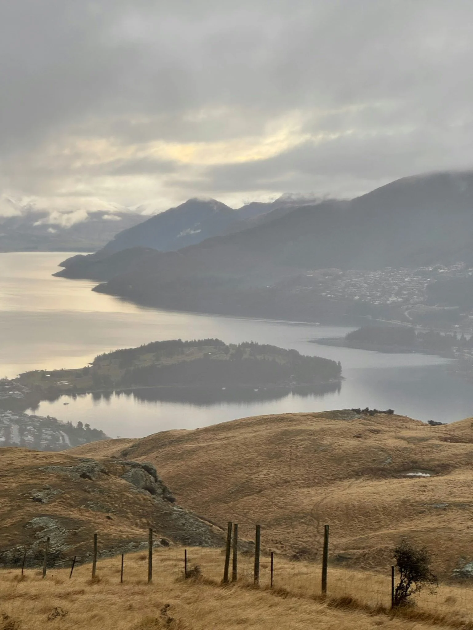 A minimalist sketch of a city street with tall buildings, including domed and spired structures, with a clock tower showing the time.