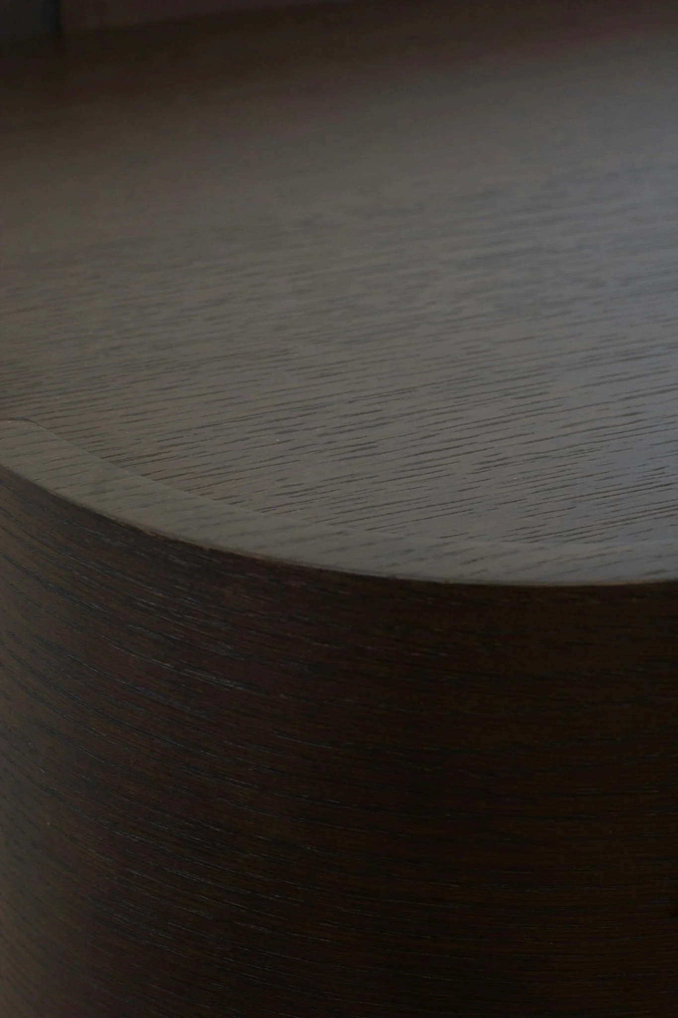 Close-up of stacked dark and light wood sheets or planks.