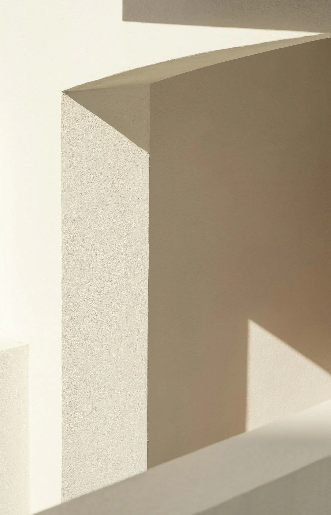 Interior view of a wooden spiral staircase seen from below, looking up at the center opening.