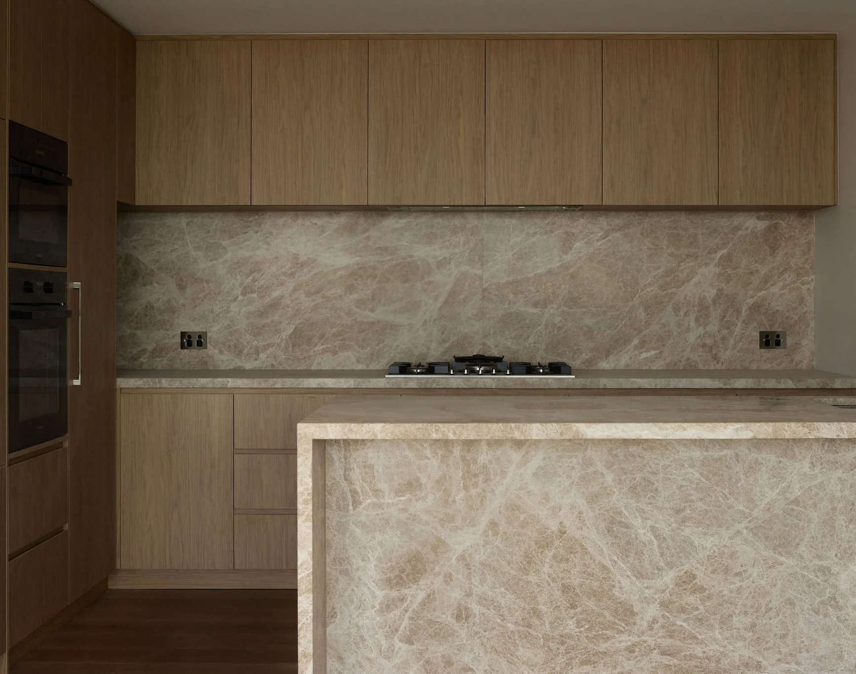 LEDA - 793 Brunswick St, New Farm. Modern kitchen with beige marble island, backsplash, and wooden cabinets.