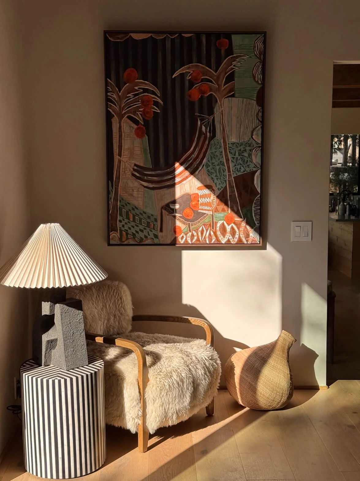 Falling Orange original painting by Anita Robinson displayed above an armchair in a Los Angeles home.