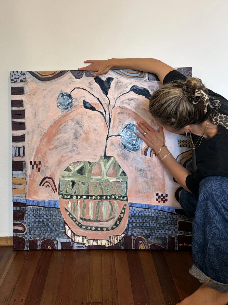 Sydney artist Anita Robinson with Hidden in the Leaves, an original abstract floral still life painting in dusky pink, blue and earthy green tones.