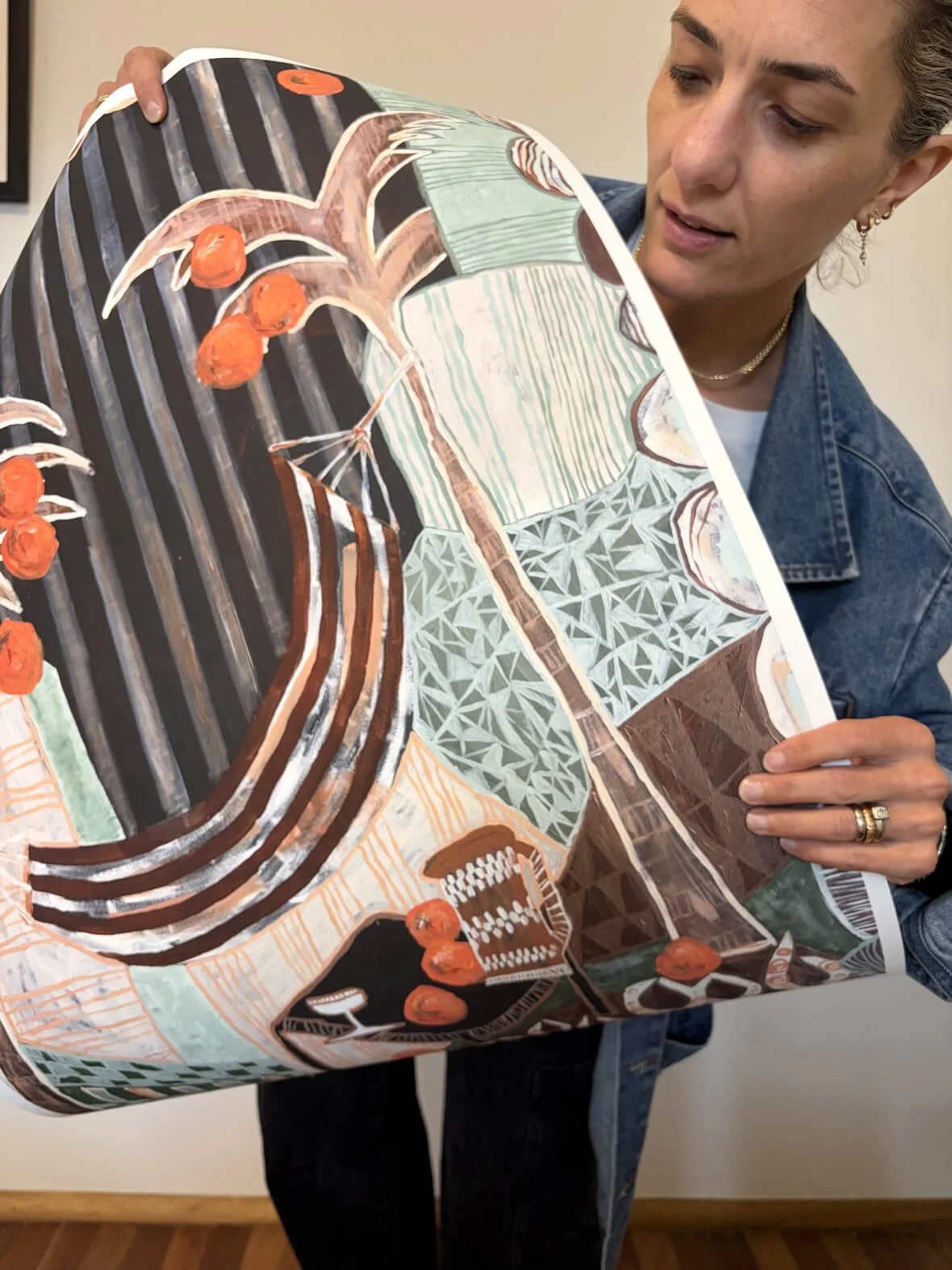 Close up of the rich terracotta, black, and warm earthy tones of the Falling Orange fine art print, showcased on heavy cotton rag paper in the studio.