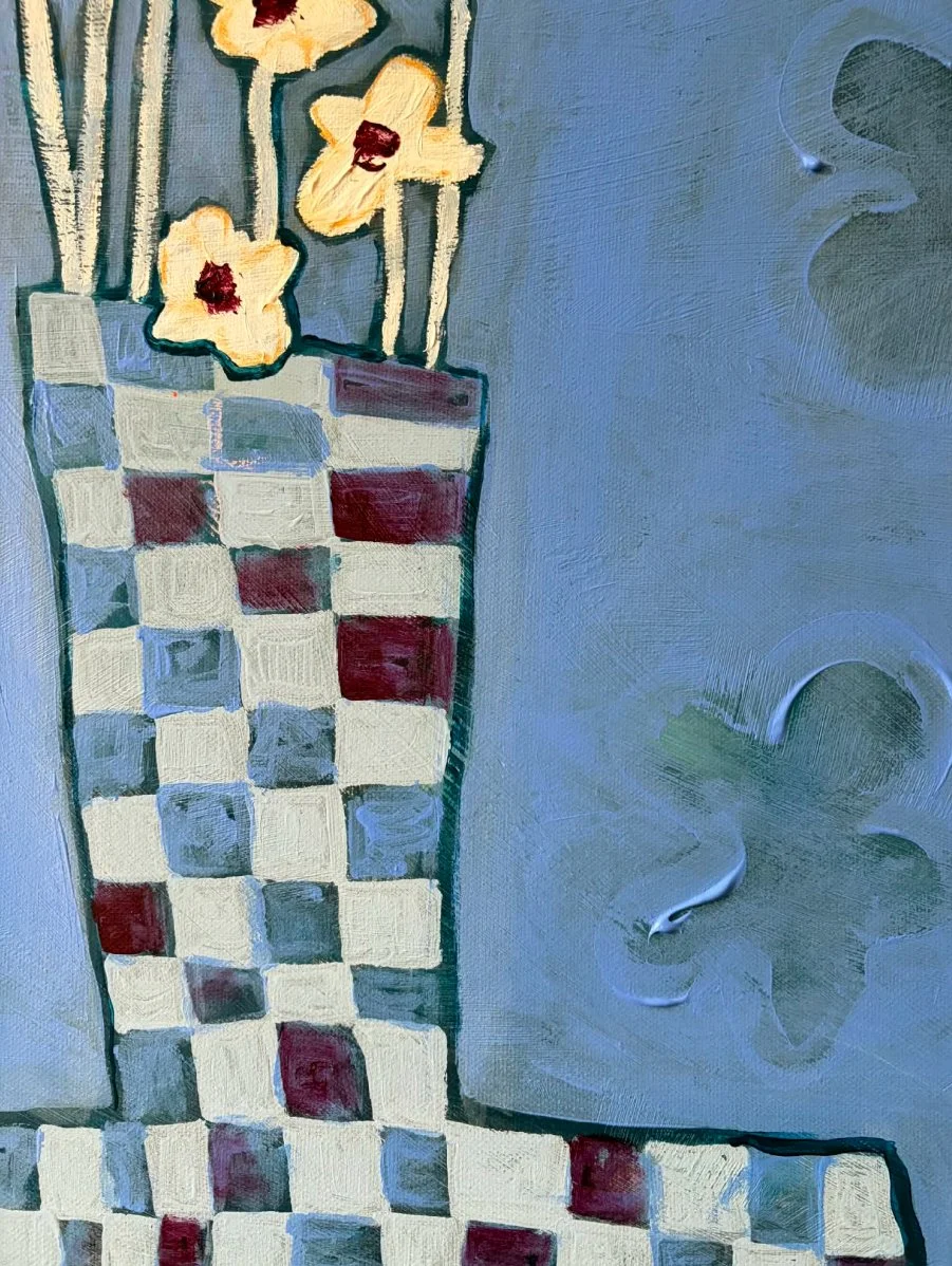 Close-up detail of a hand-painted blue, white, and purple checkered vase with thick, expressive acrylic texture.