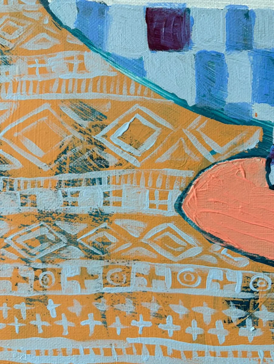 Macro shot of the bottom border detail featuring an intricate ochre and white geometric pattern contrasted against a peach-toned base.