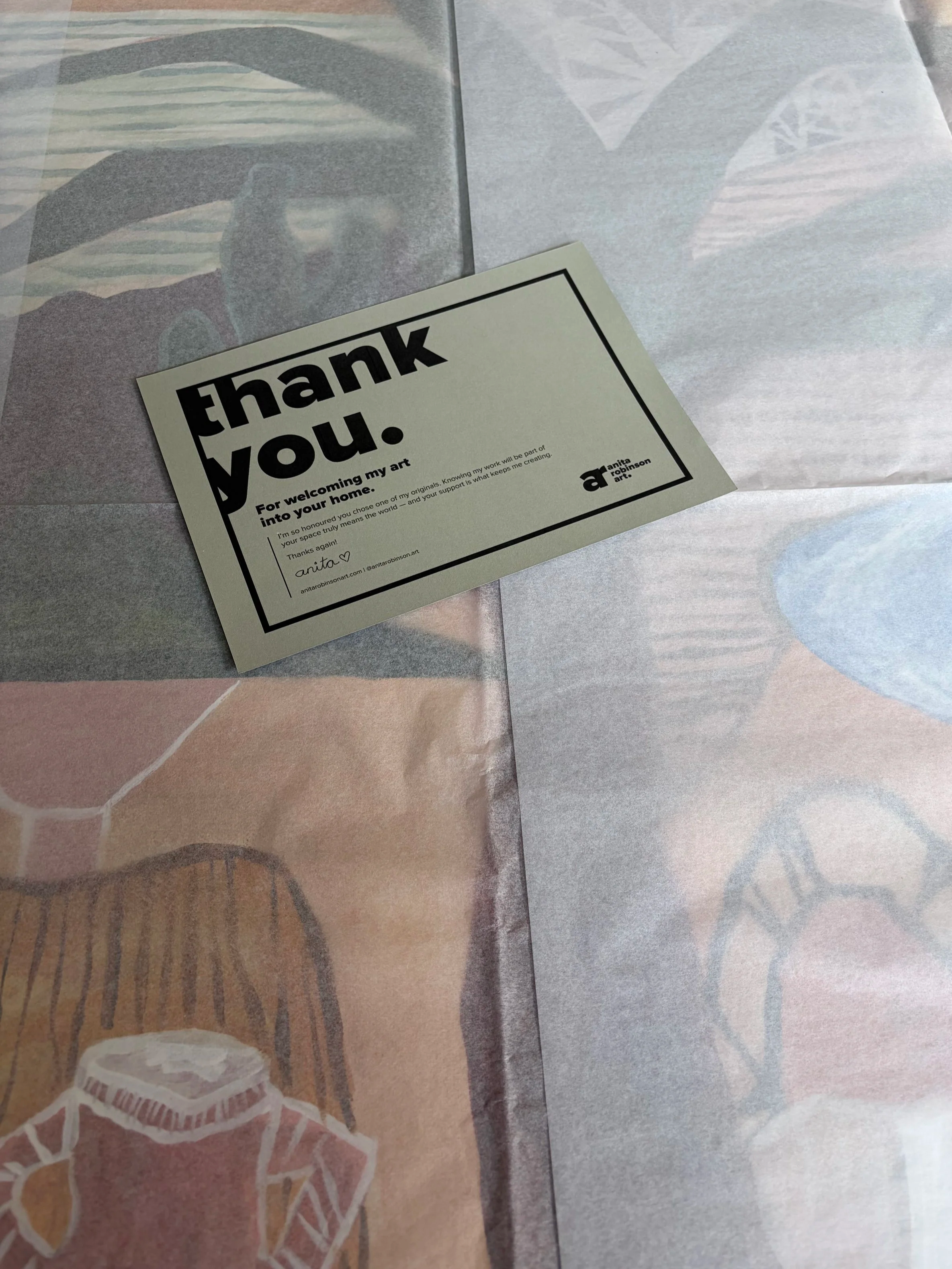 Artist Anita Robinson preparing an original painting for shipping in her studio