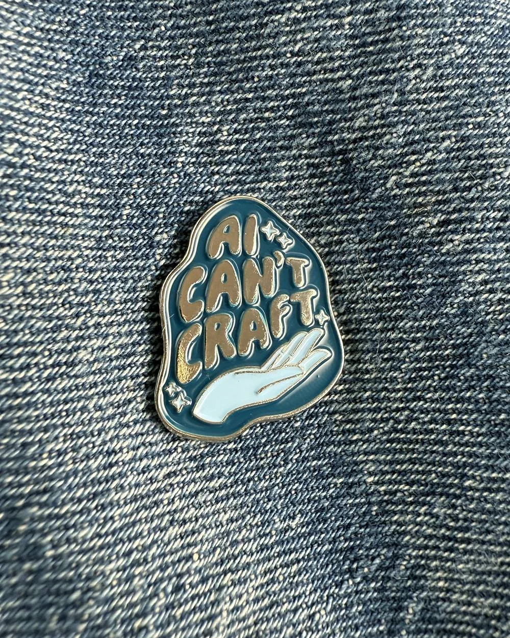 NEW! ✨ "AI Can't Craft" has been our most popular design and for good reason: crafters know that nothing's better than handmade. Now get this design as an enamel pin or holographic sticker - available now at link in bio!

#antiai #makers #c