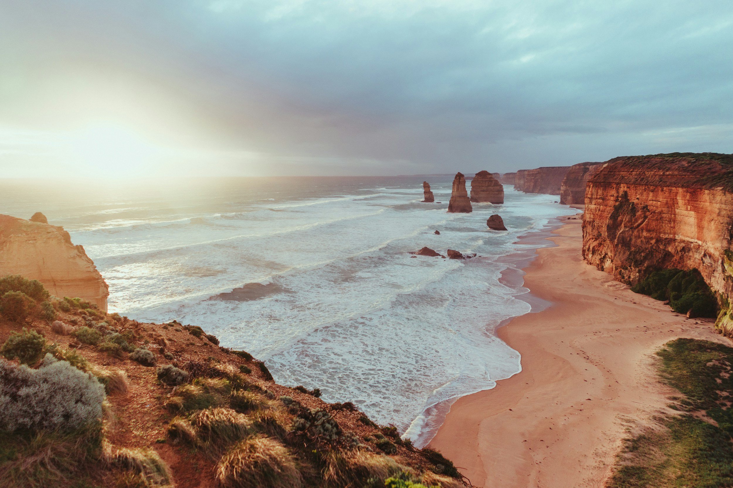 A breathtaking elevated view of the Twelve Apostles limestone sea stacks along the rugged Victorian coastline, symbolising enduring structure, deep time, and Indigenous-led enterprise strategy for Bunjilview.