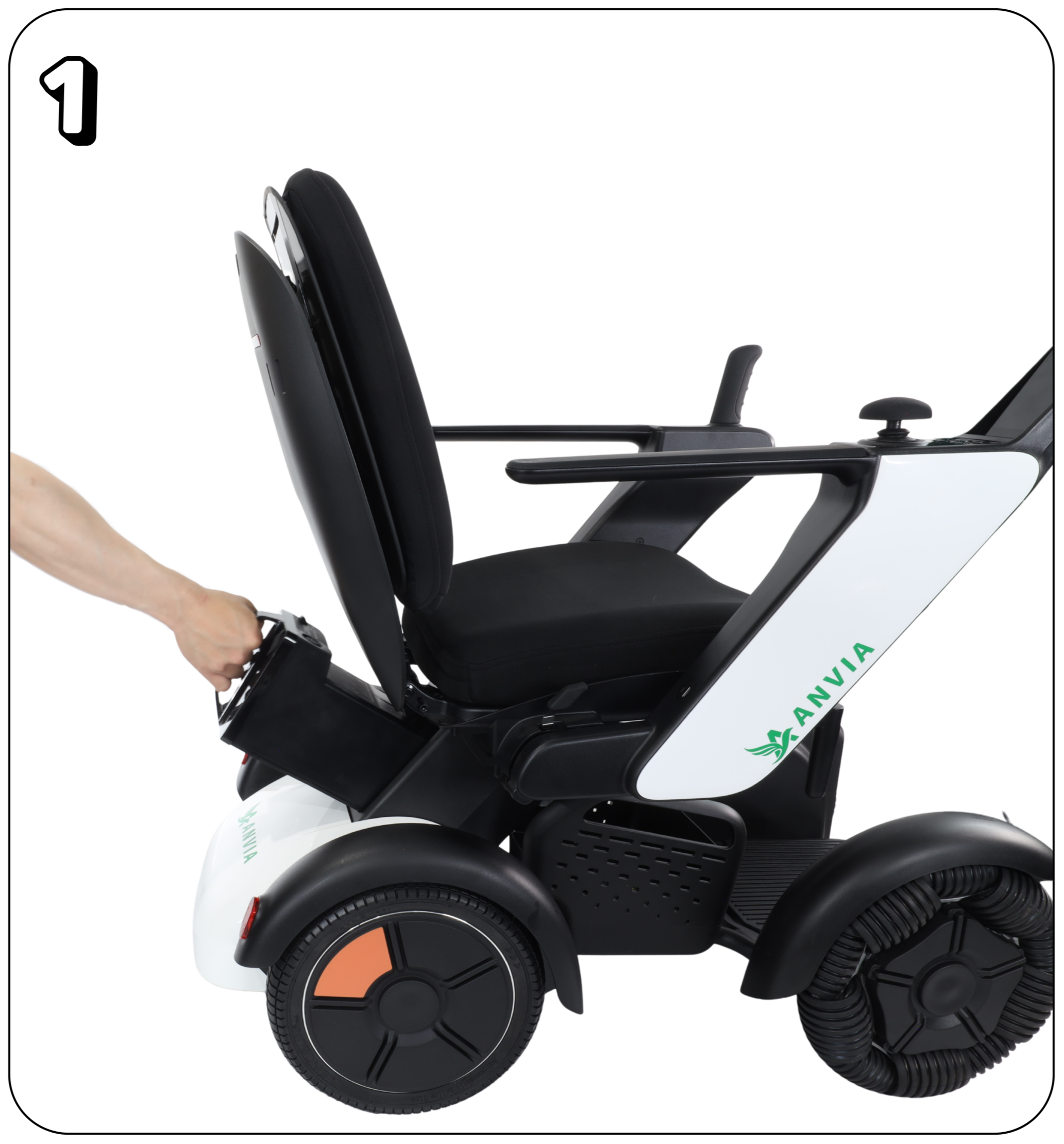 A robotic wheelchair with a white body, black cushioned seat and backrest, and large black wheels with orange and gray accents. The wheelchair has black armrests and a control panel on the right side. A person’s arm is extending to operate the chair.