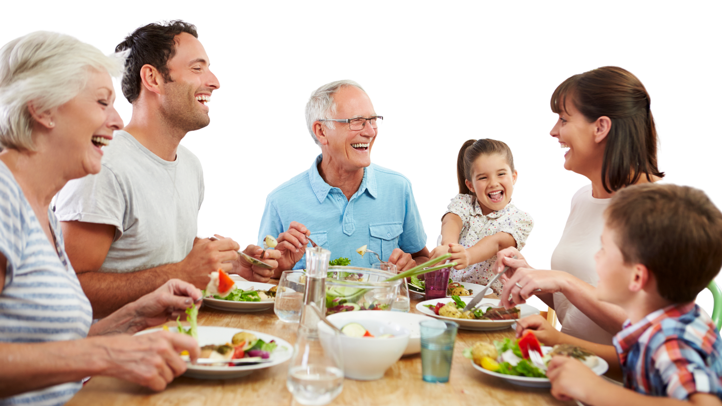 Family and friends gathered around a dining table, laughing and sharing a meal together.