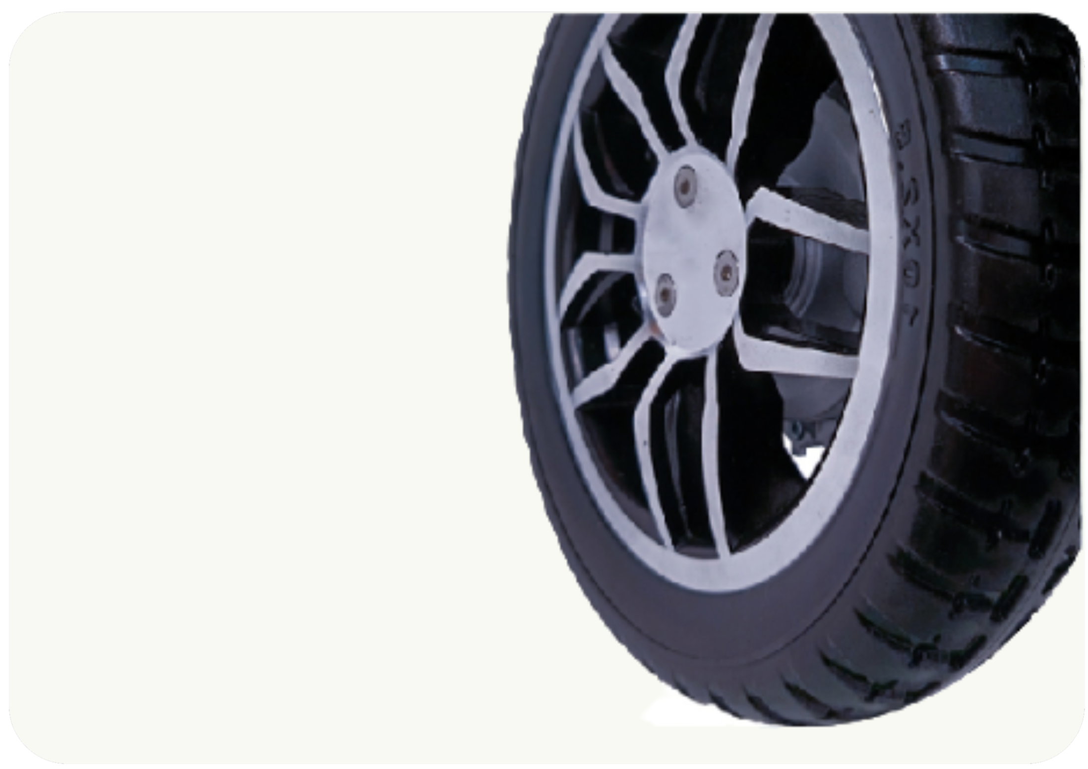 Close-up of a black and silver car wheel with a tire, isolated on a white background.