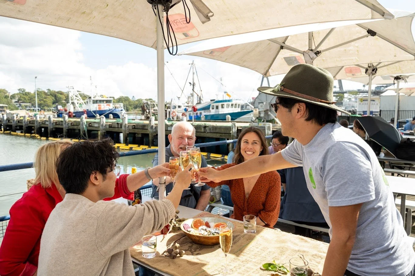 Guests enjoying a premium Sydney Harbour seafood food tour with drinks and local host The Australian Food Guy