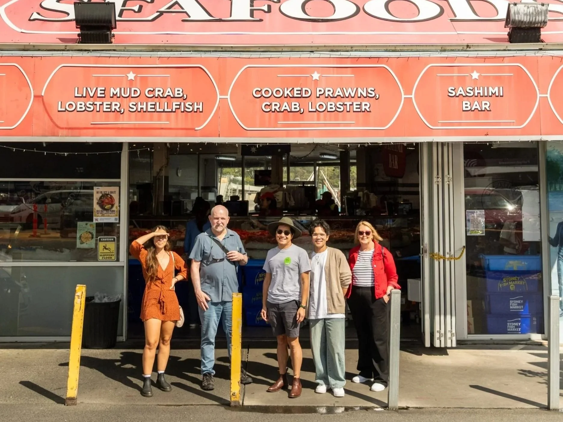 Travellers exploring Sydney Fish Market with a local guide on a premium Sydney food experience
