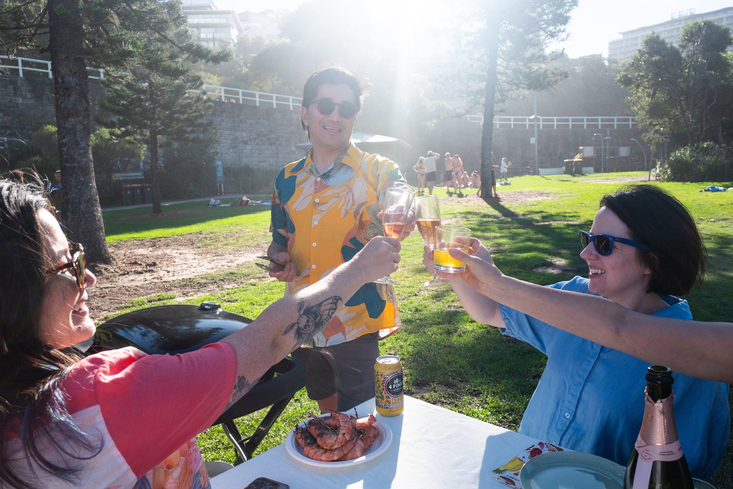 Guests enjoying a premium Sydney Beach BBQ experience with fresh seafood, drinks and local host The Australian Food Guy