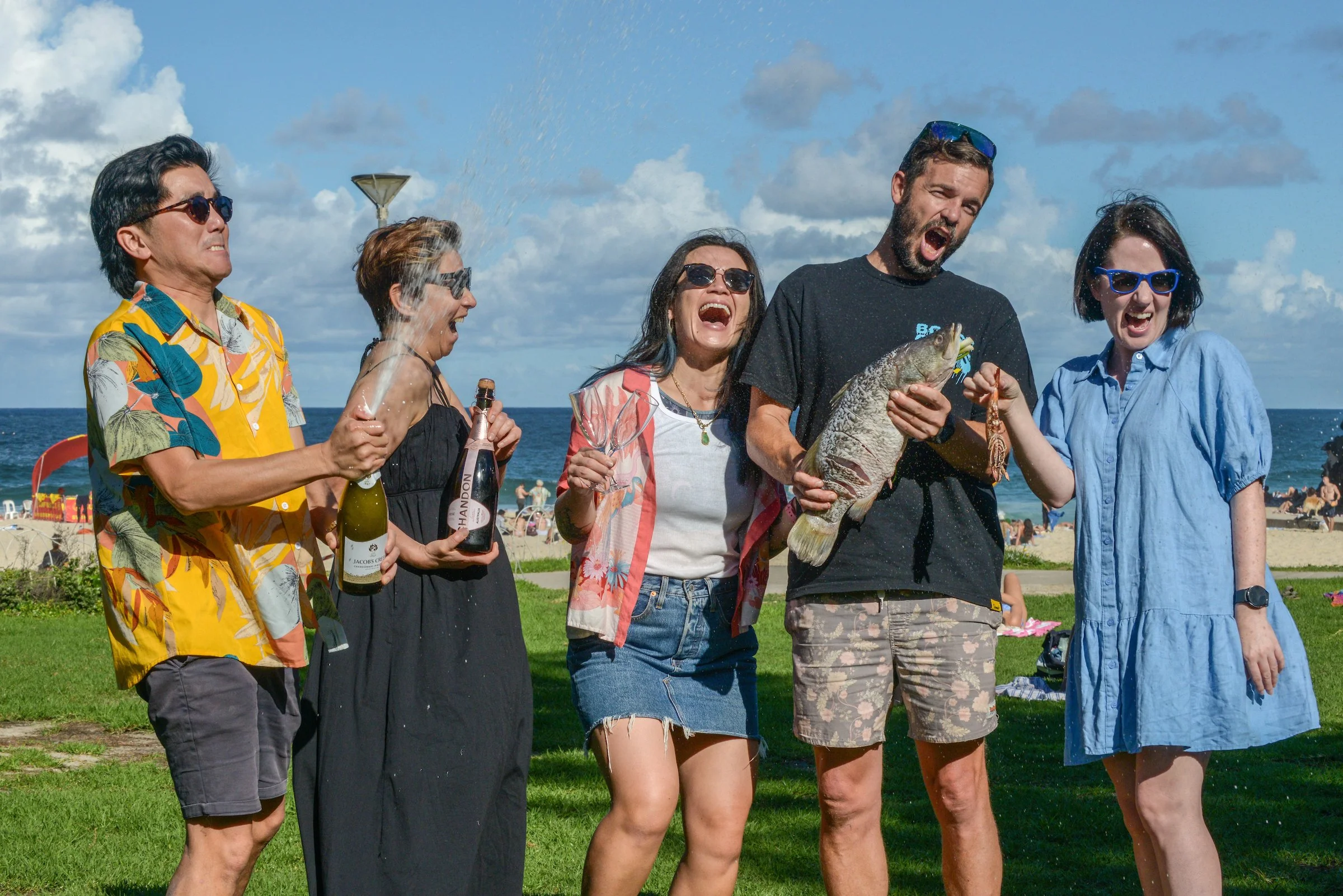 Travellers enjoying a premium Sydney Beach BBQ food tour with fresh seafood and local host The Australian Food Guy