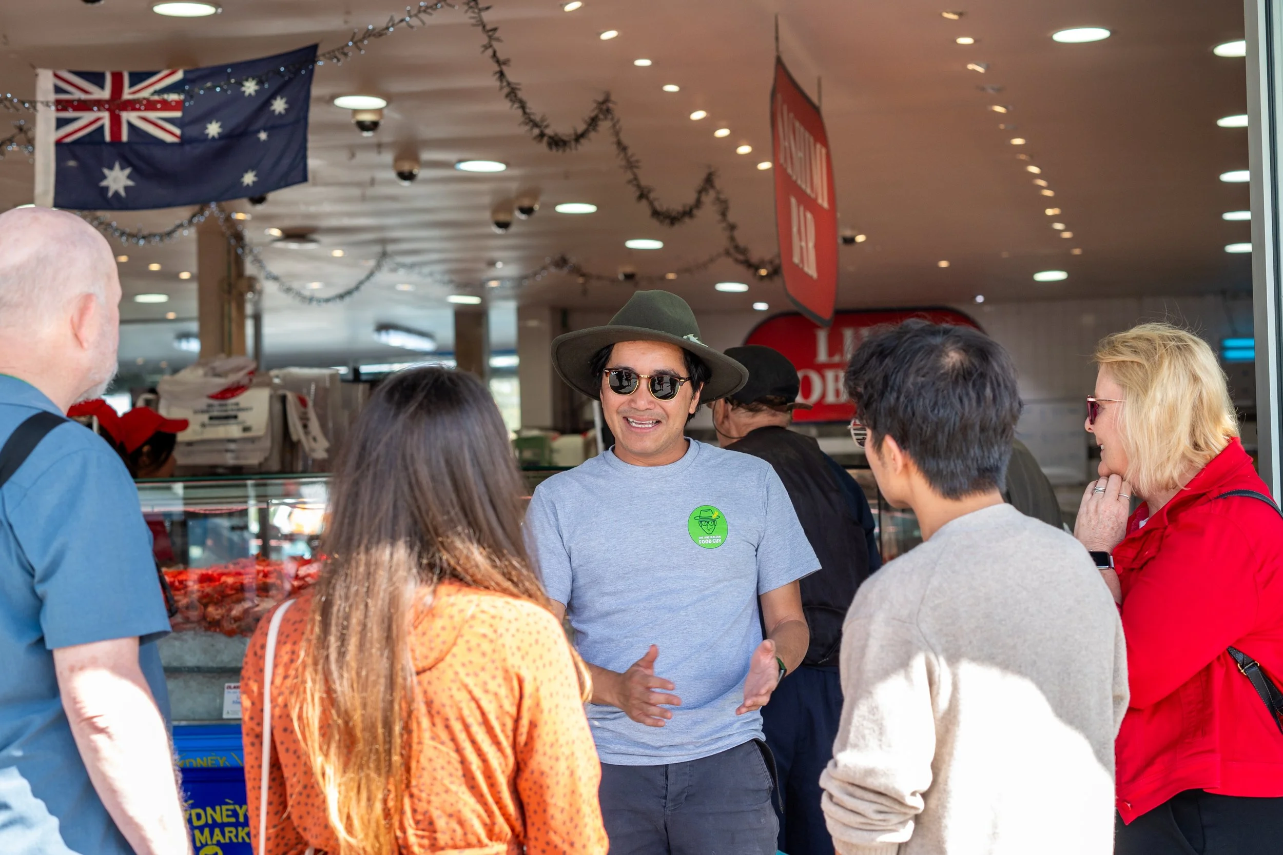 Guide with Guests at Fish Market
Description: The Australian Food Guy leading a small group through Sydney Fish Market, sharing insider stories about oysters, seafood and bush tucker. An authentic Sydney walking food tour that goes behind the scenes