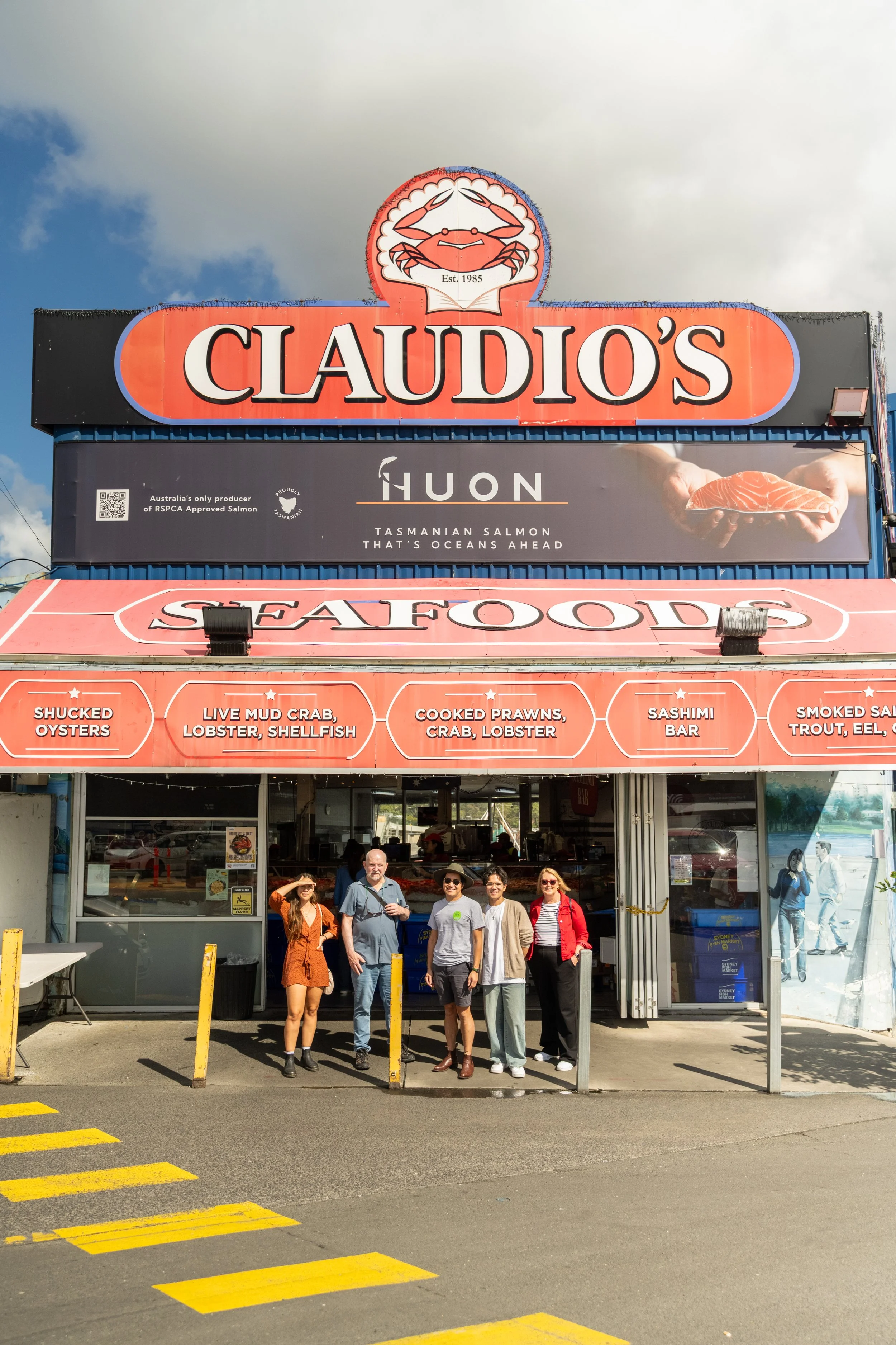 Group Outside Claudio’s Seafood
Description: Guests with The Australian Food Guy outside Claudio’s Seafood at Sydney Fish Market. A highlight stop on the Sydney food tour, showcasing Australia’s freshest seafood and native flavours.
Alt Text: Tour g