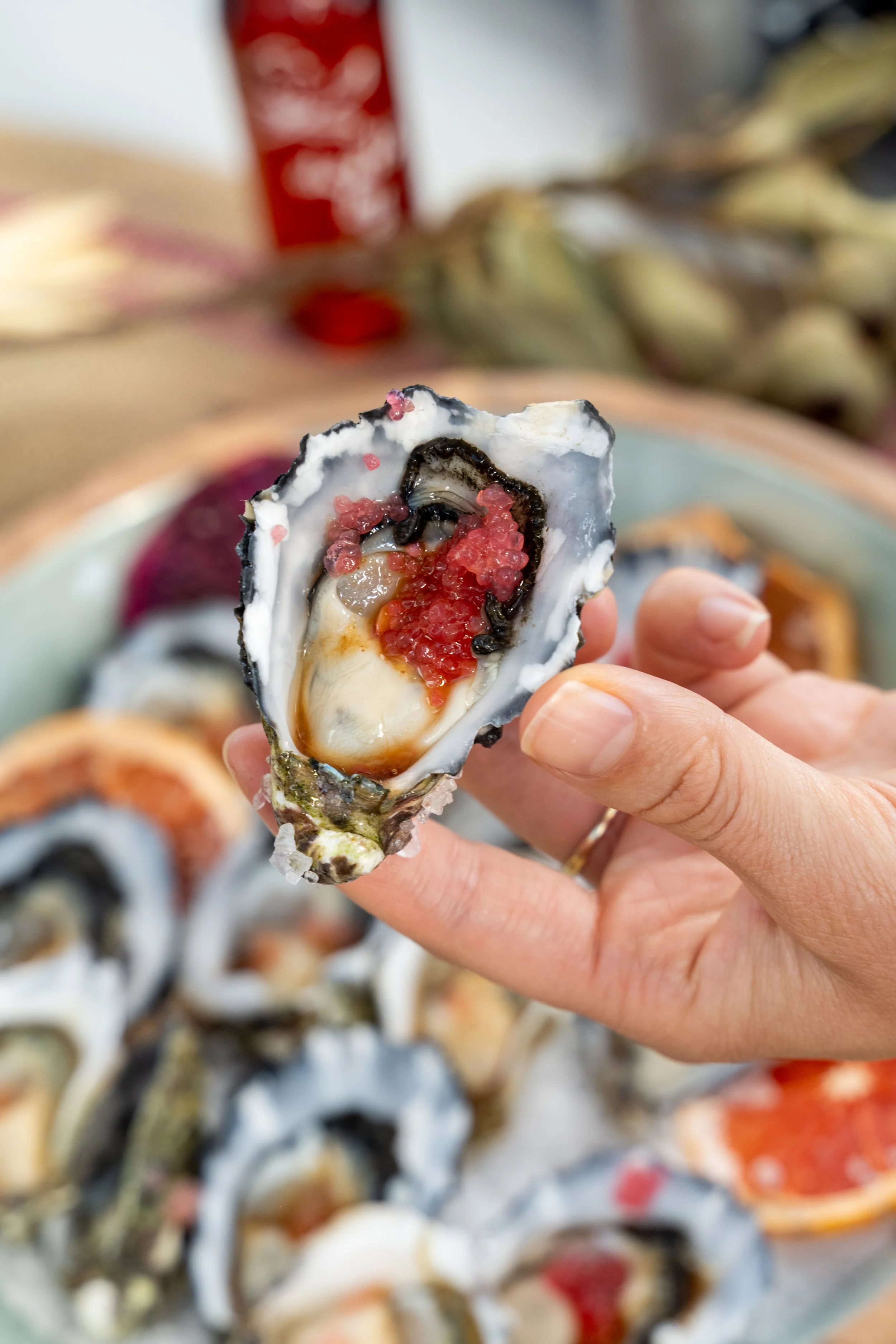 Oyster with Finger Lime
Description: Fresh Sydney Rock Oyster topped with zesty finger lime during The Australian Food Guy Sydney food tour. A native Australian food highlight that connects land and sea.
Alt Text: Hand holding Sydney Rock Oyster top