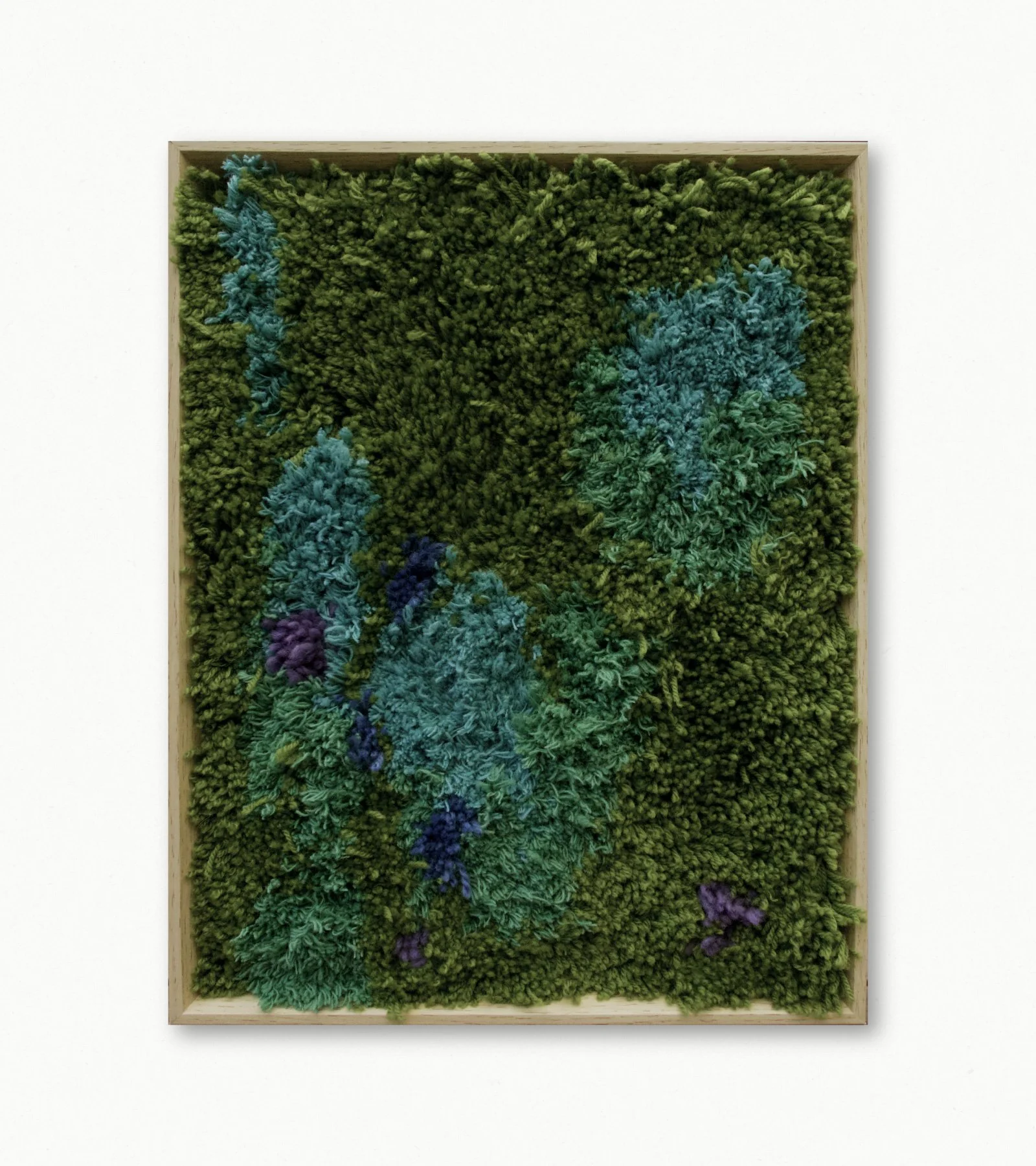 A mixed-media artwork featuring textured, colorful yarn and fabric resembling a forest scene with trees and foliage, framed in a wooden border.