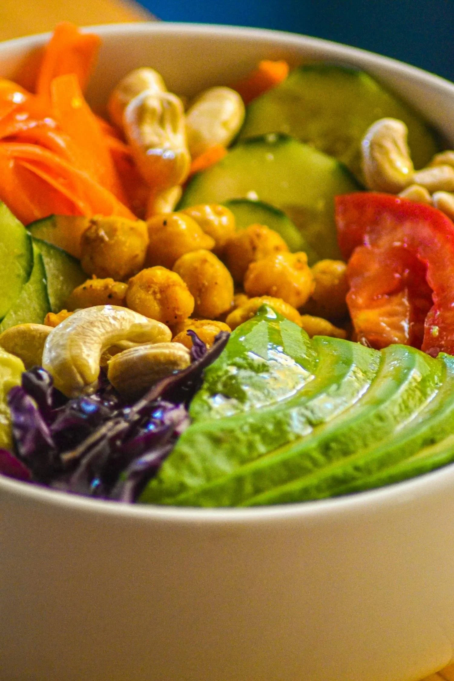 Colourful bowl of chickpeas cashews avocado and other vegetables