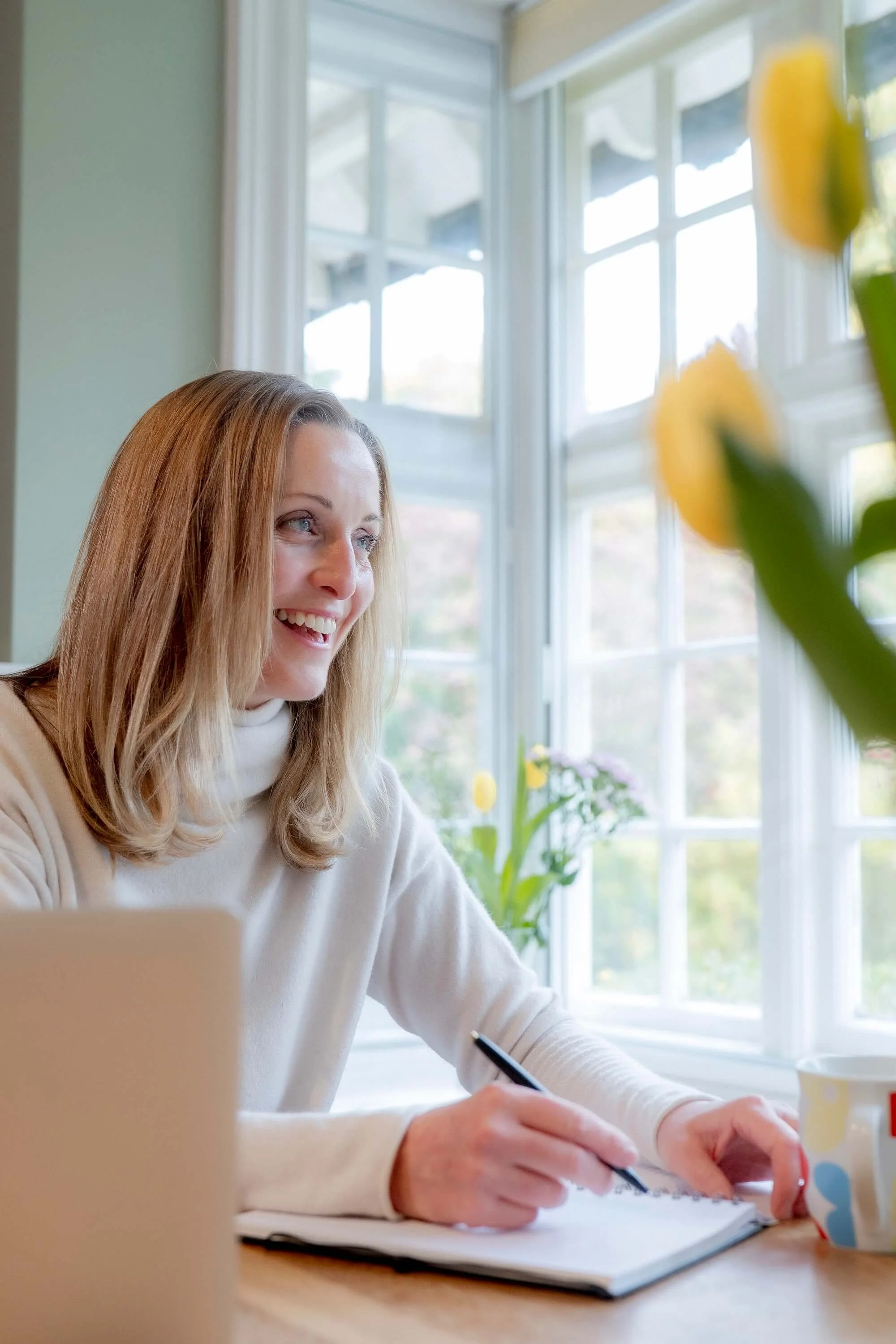 Niamh Ward, Registered Nutritionist and Health Coach, at work smiling