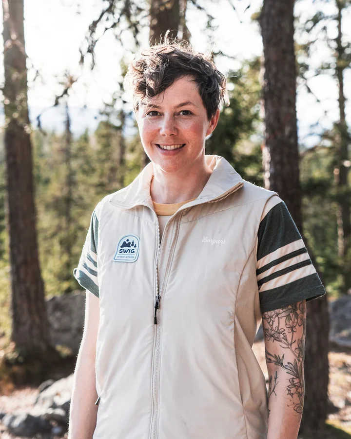 A photo of a short haired woman smiling into the camera.