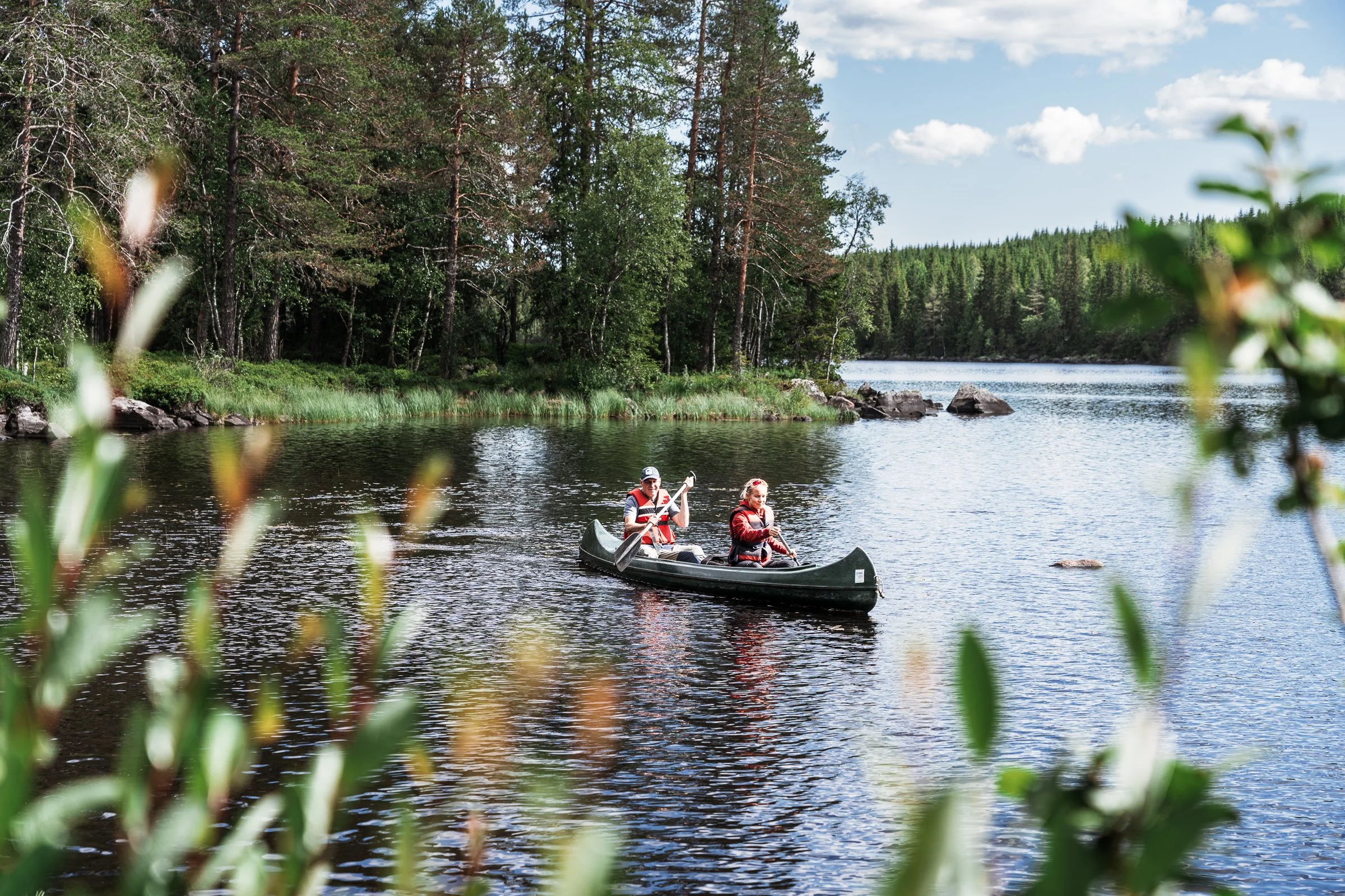 Couple paddling a canoe during a guided canoe tour near Lillehammer in Norway