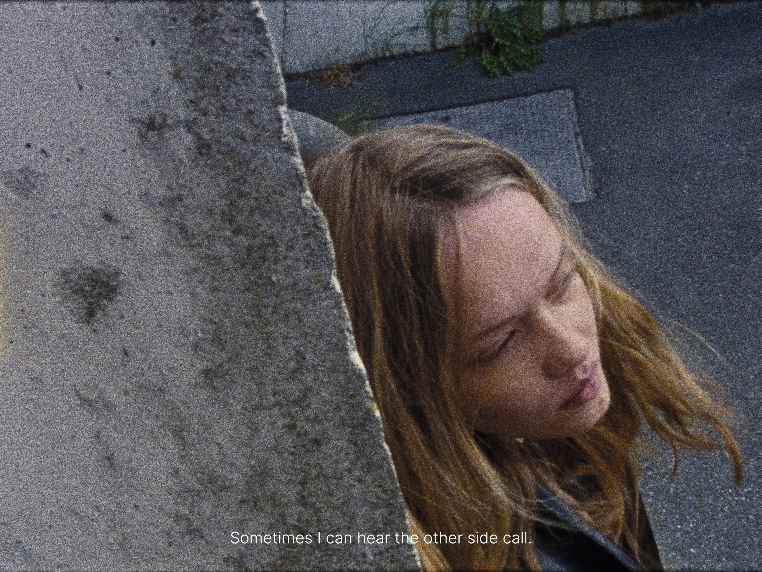 A young woman with long, wavy brown hair leaning against a concrete wall, with her eyes closed and a thoughtful expression. Text overlay says: "Sometimes I can hear the other side call."