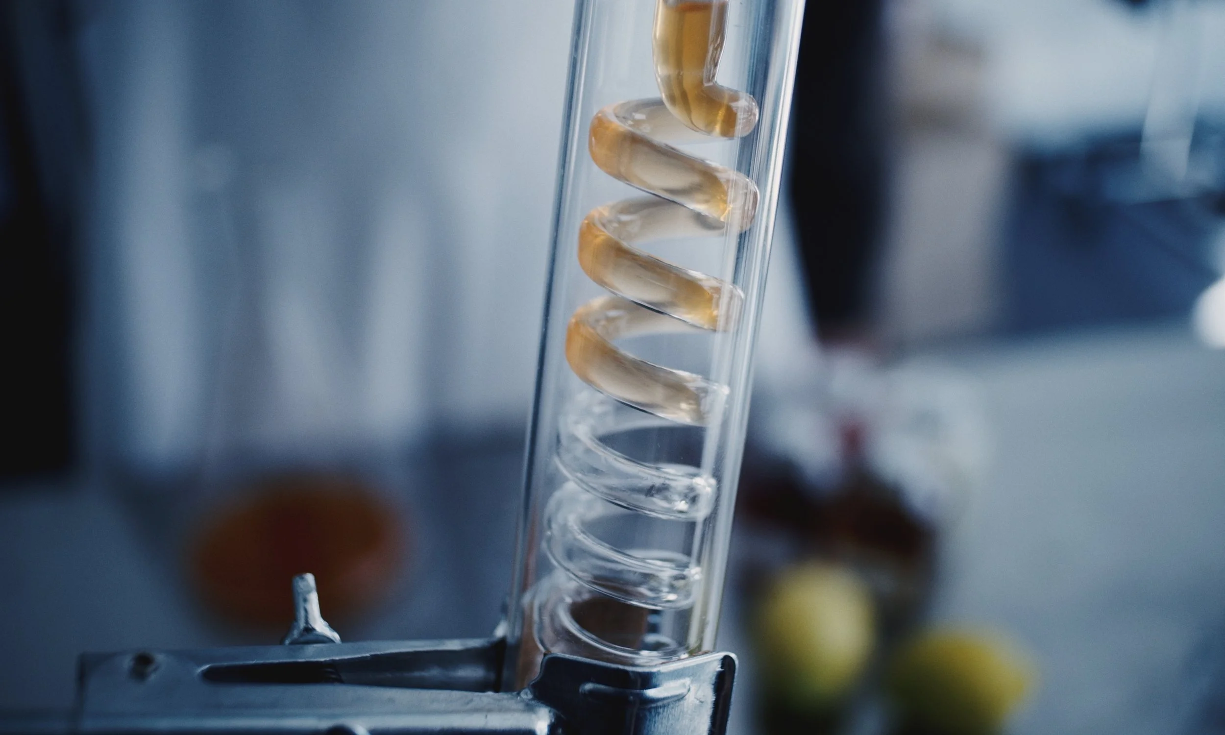 A glass test tube with a spiral glass stirring rod inside, often used in chemistry laboratories.