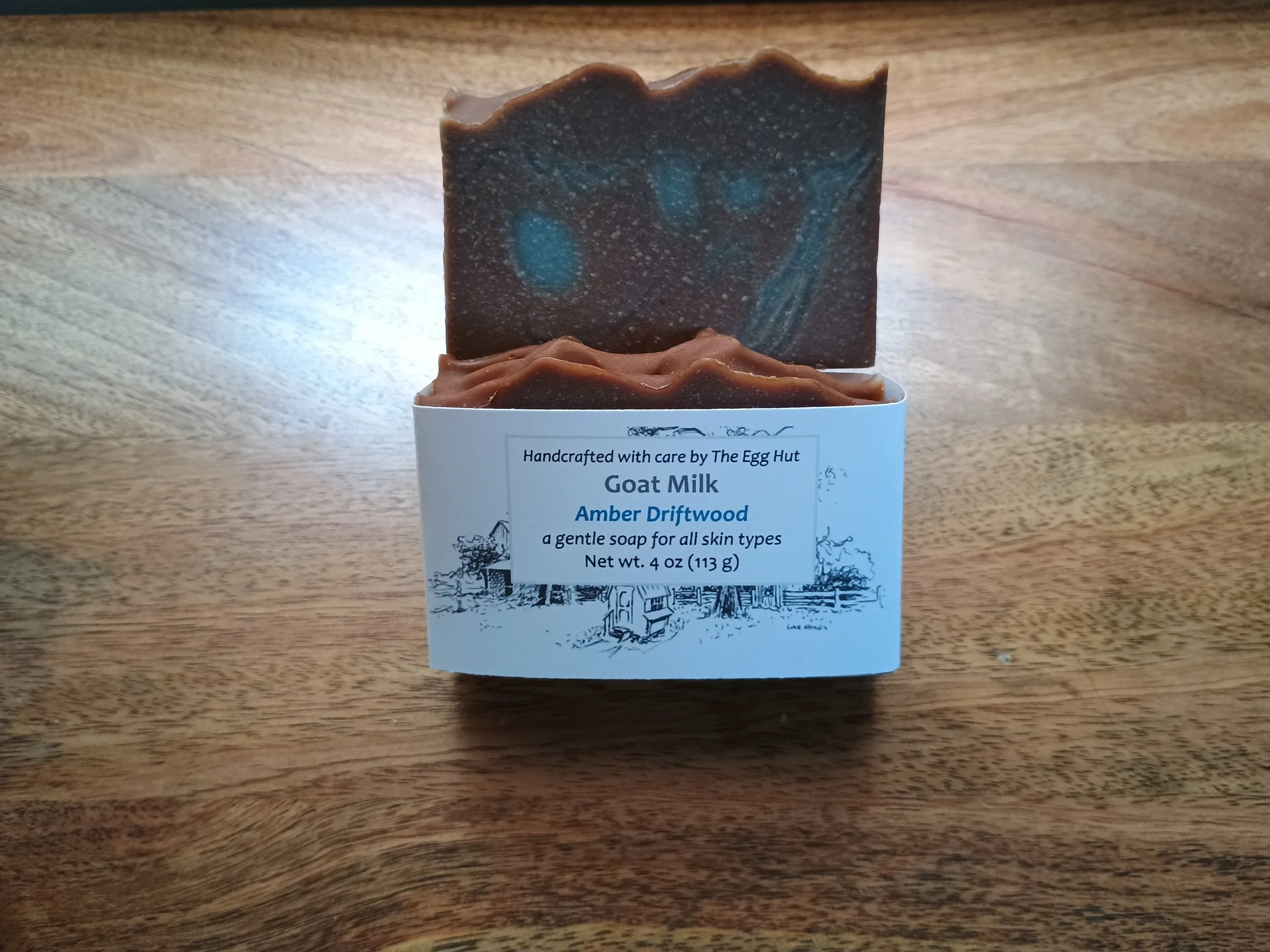 Amber Driftwood soap package and brown soap with teal colored droplets
