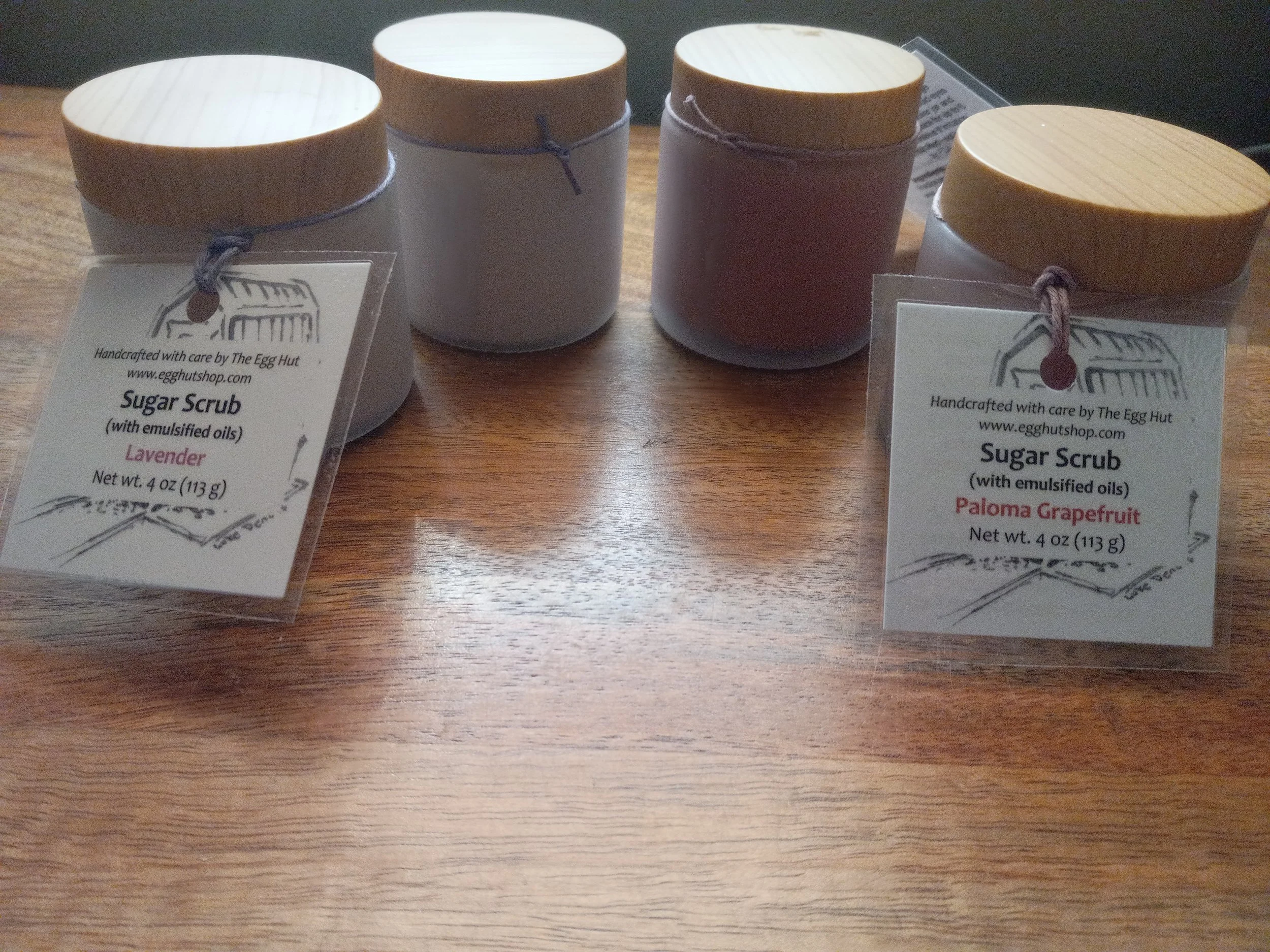 2 lavender and 2 paloma sugar scrubs in frosted jars.