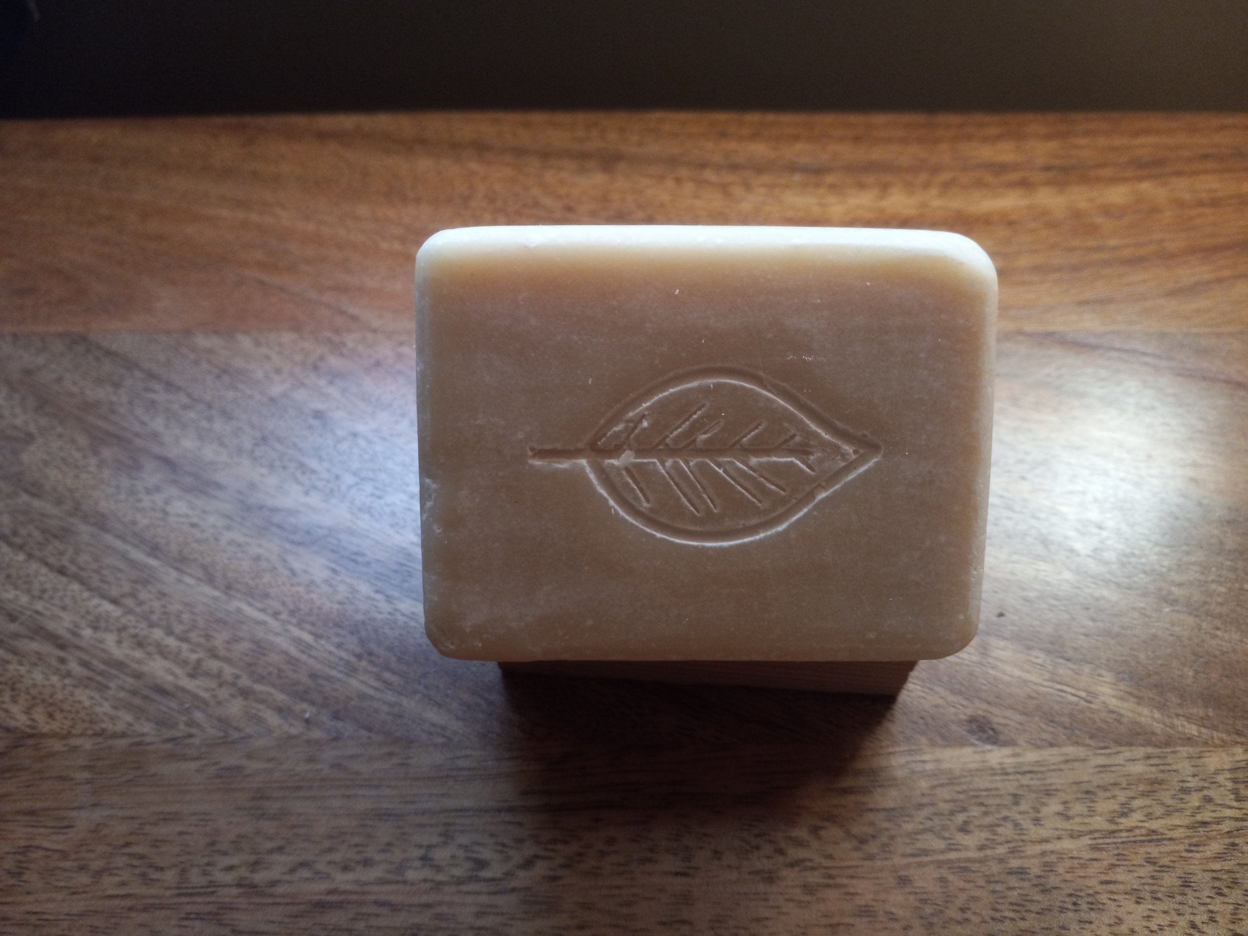 creamy soap bar with leaf imprint.