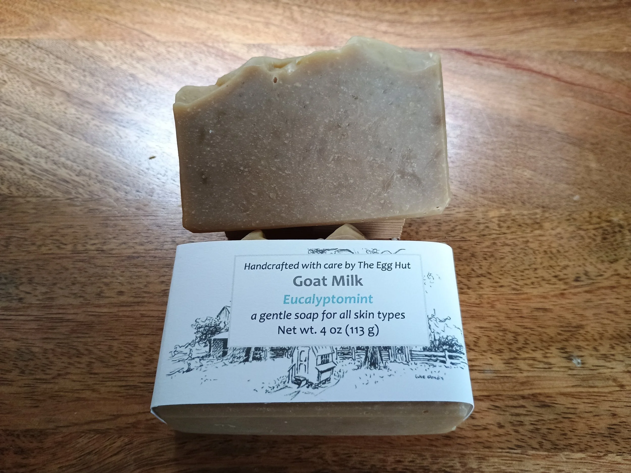 Eucalyptomint Soap package and dark tan soap with green swirls