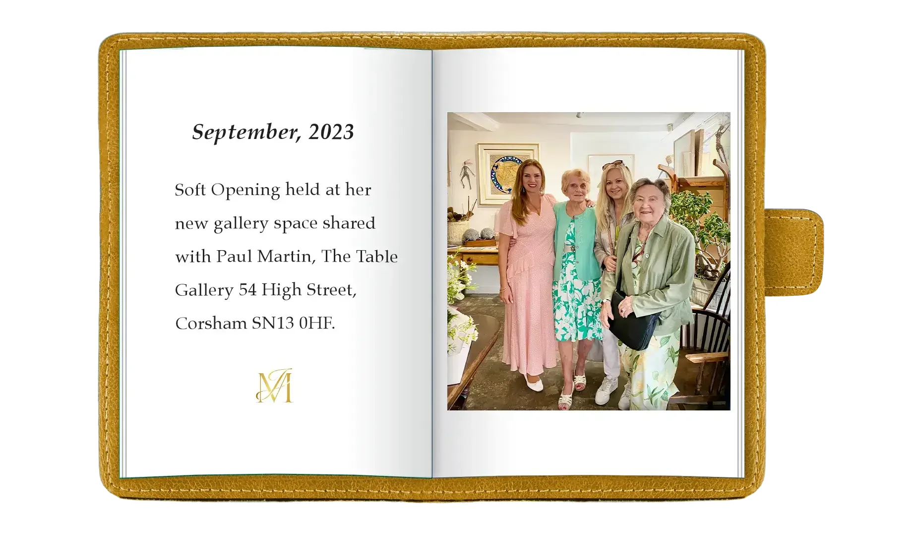 Open photo album page with text about a gallery opening and a photo of four women standing together at an art gallery, smiling.